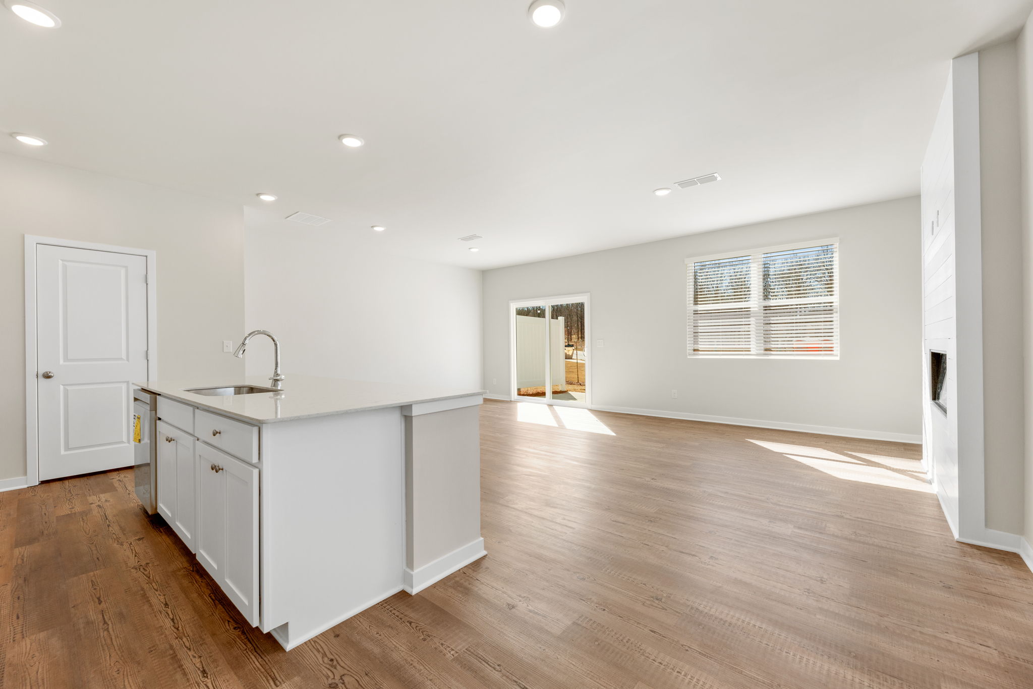 A large empty room with white cabinets.