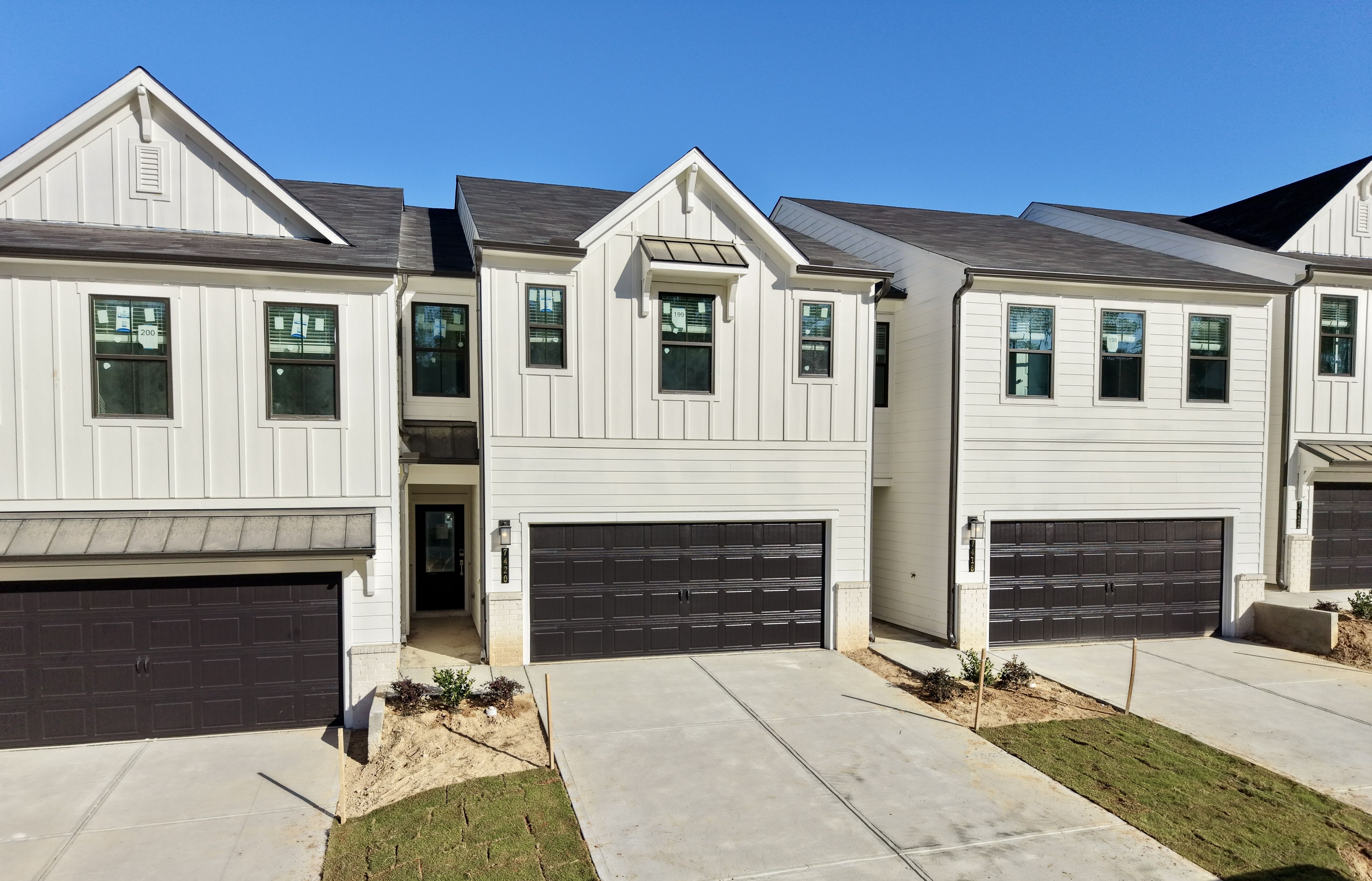 A white house with a garage.