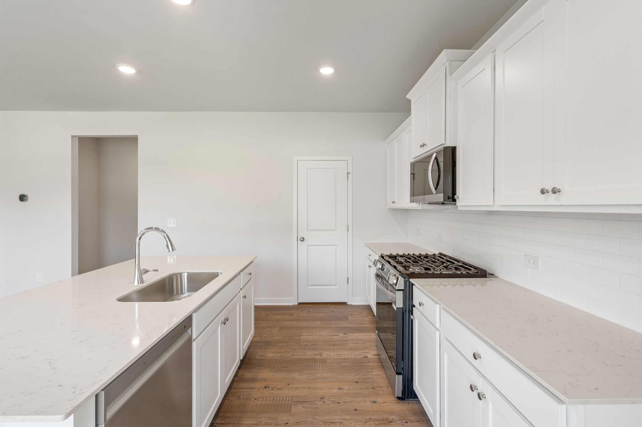 A kitchen with white cabinets.