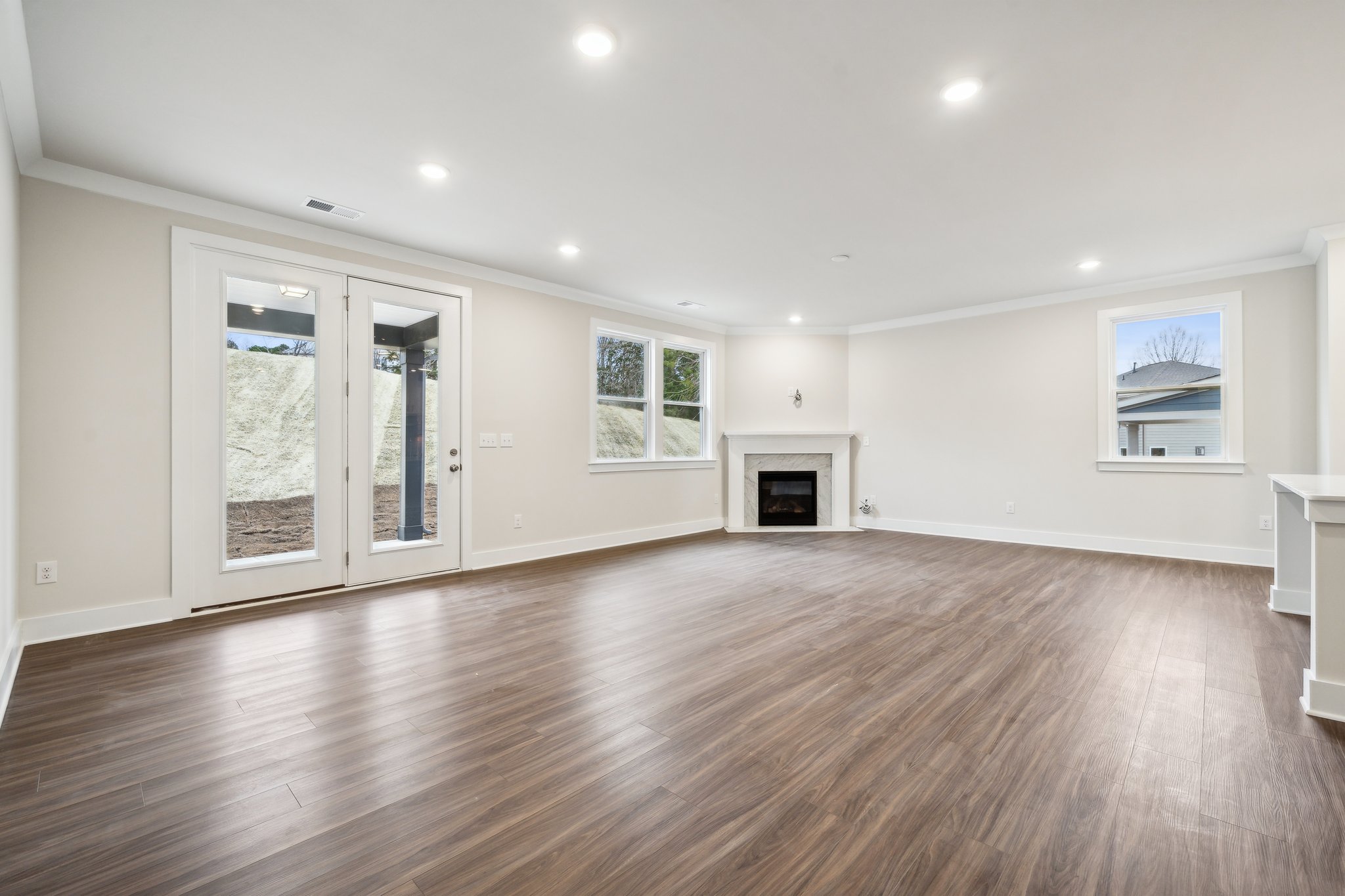 A large empty room with a fireplace.