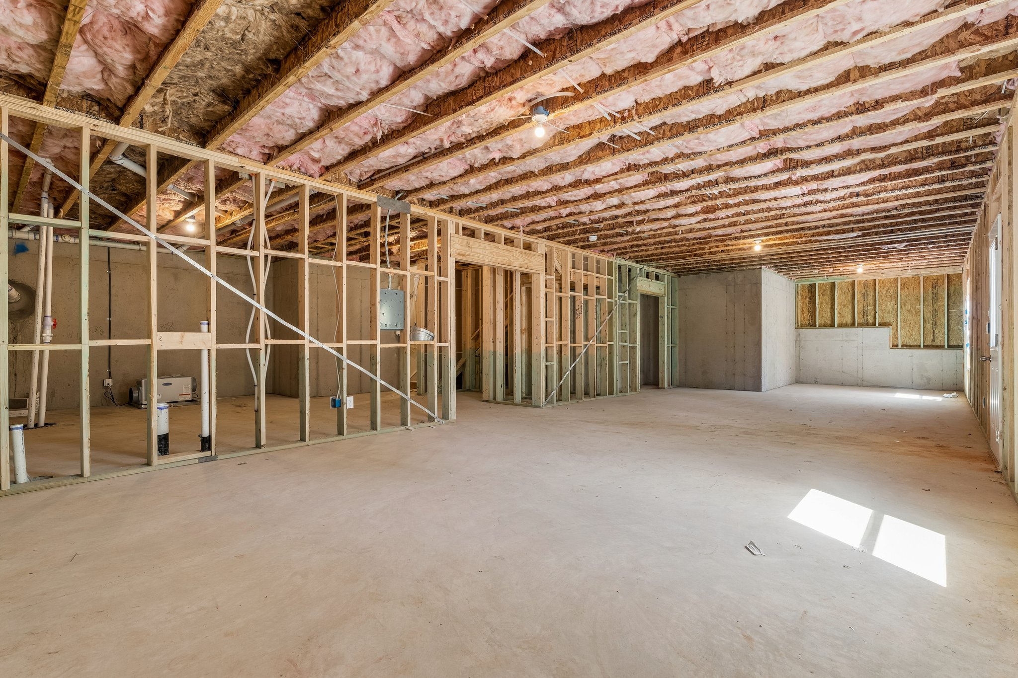 A room with a wood ceiling.