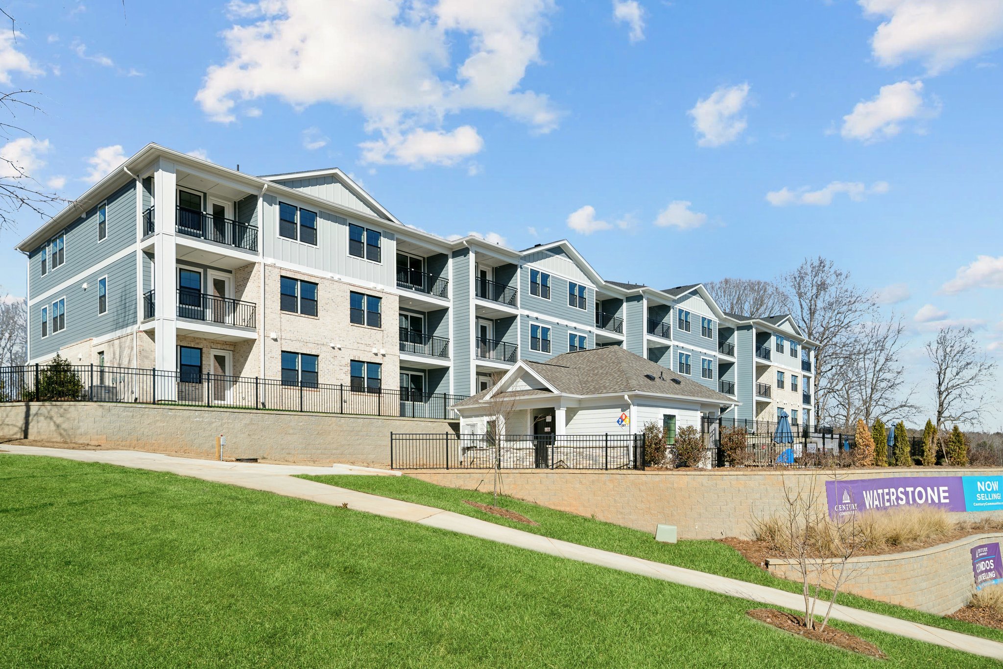 A large white building with a lawn in front of it.