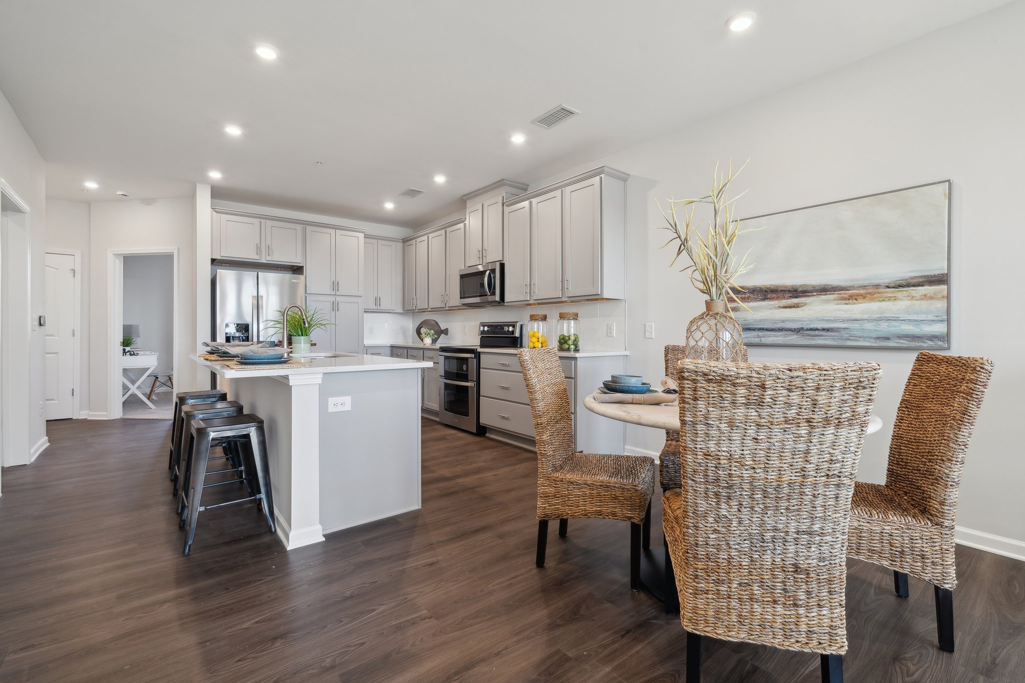 A kitchen with a dining table and chairs.