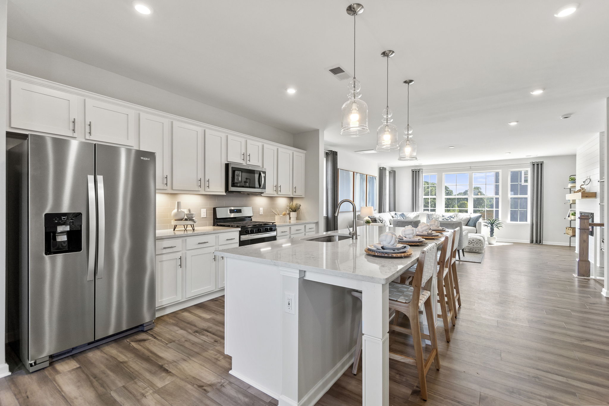 A kitchen with white cabinets.