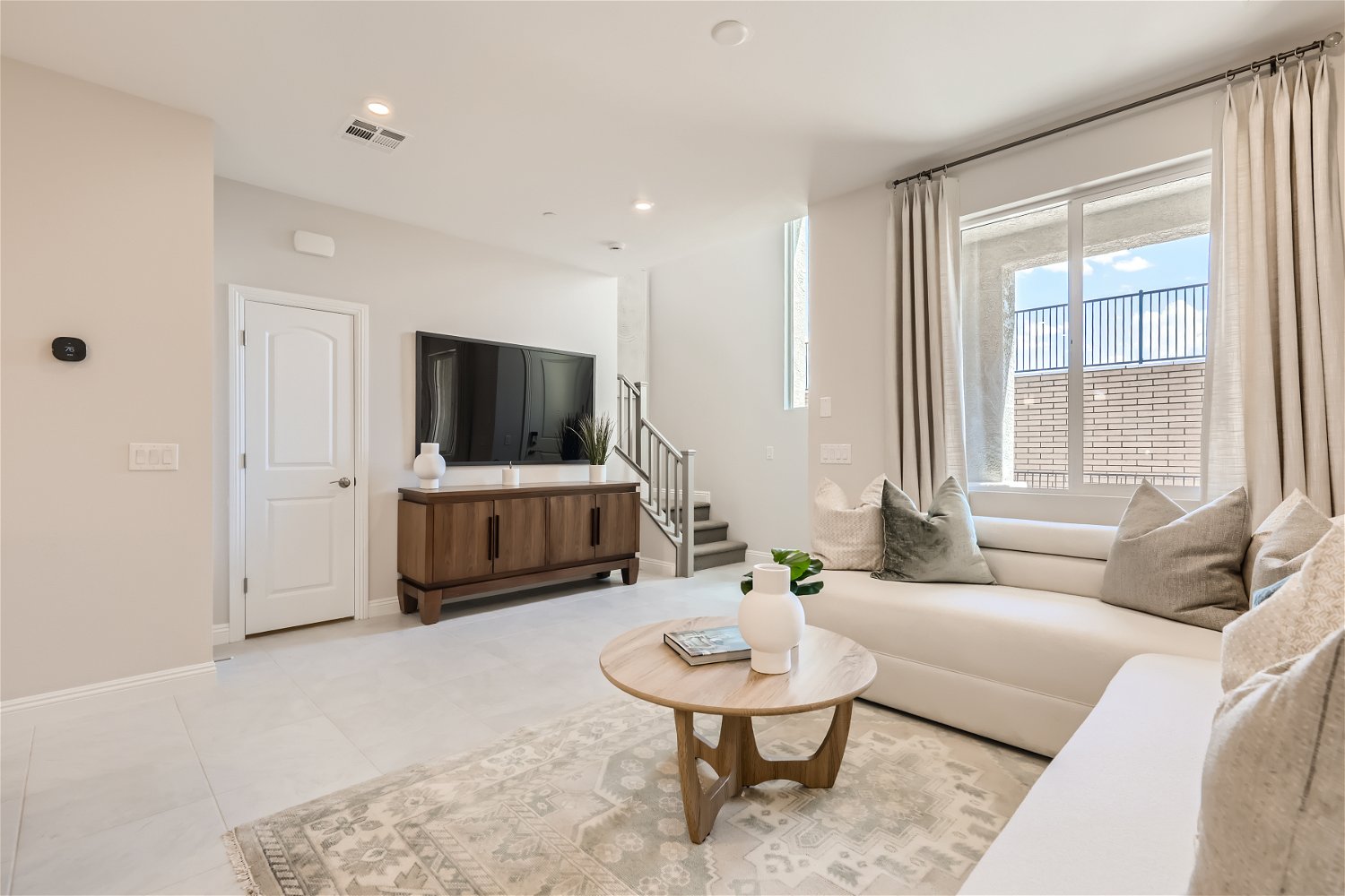 A living room with a tv and couches.