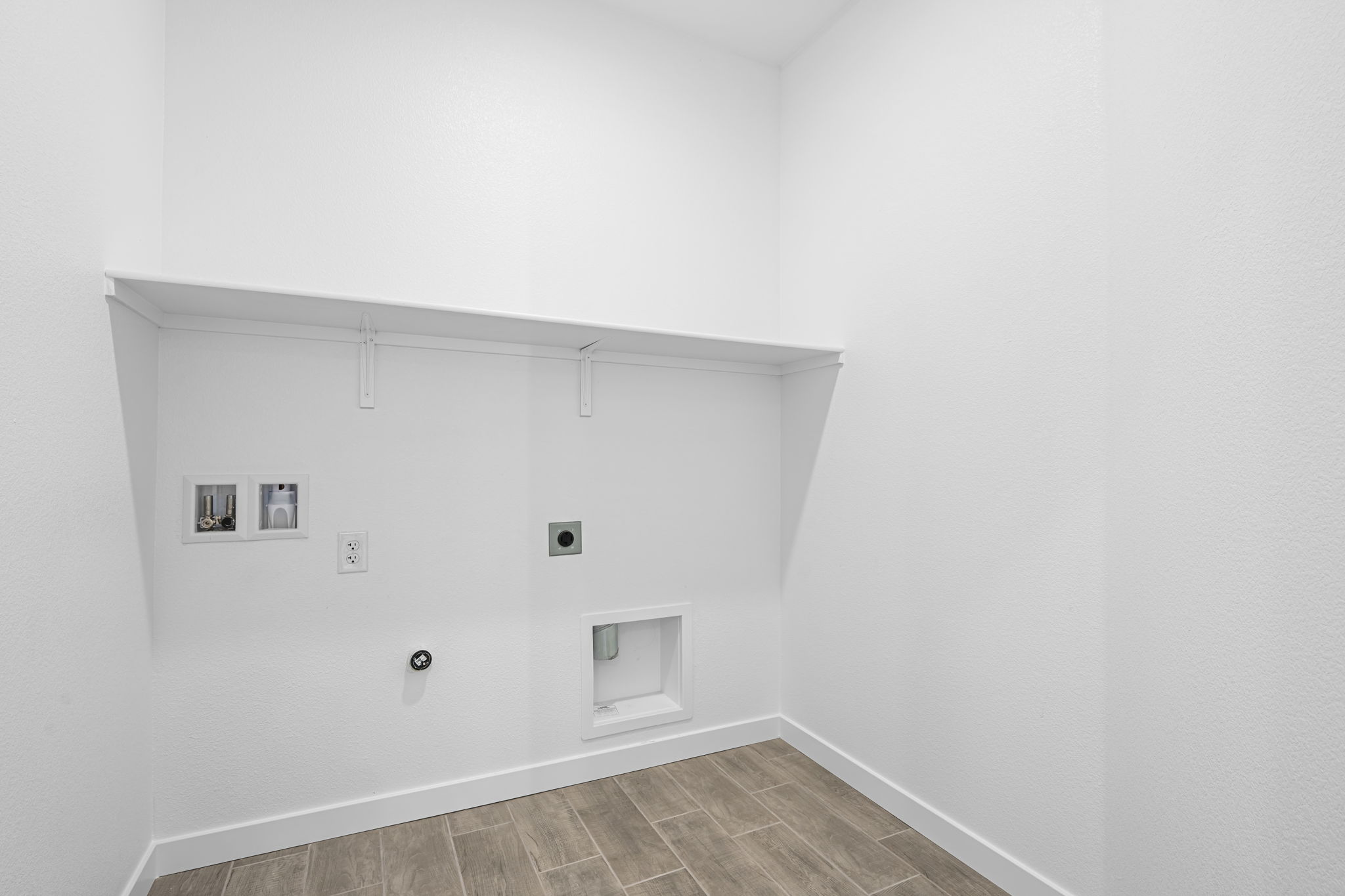 A white wall with pictures on it.