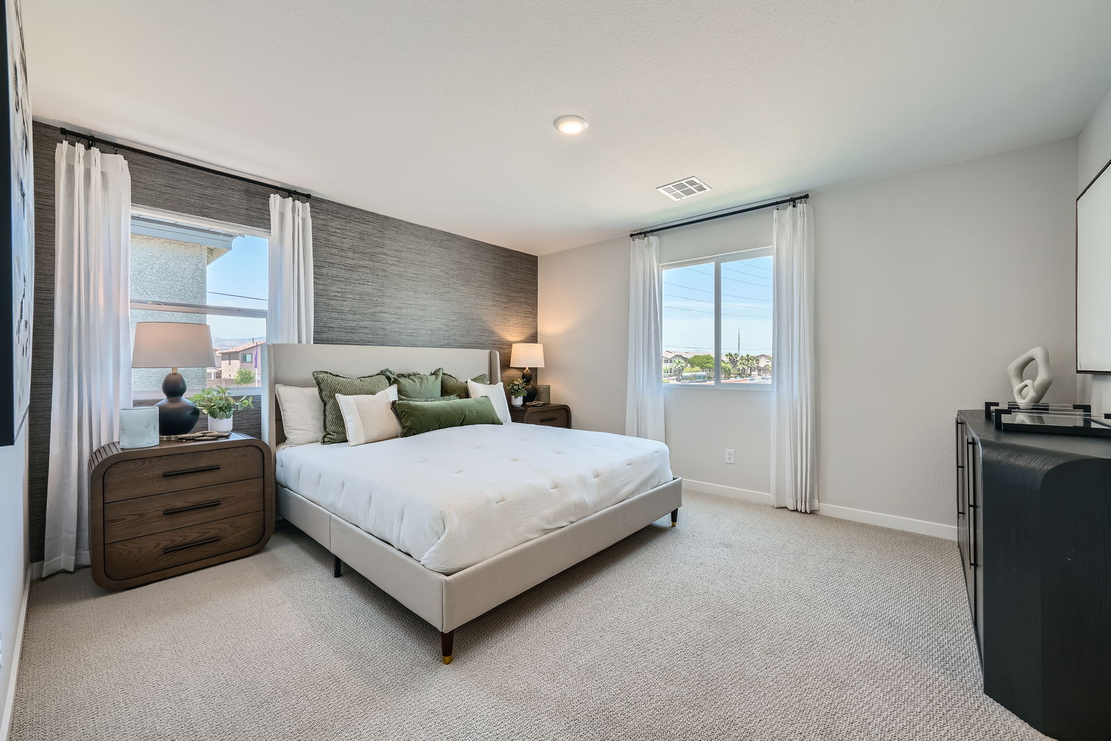 A bedroom with a bed and a dresser.