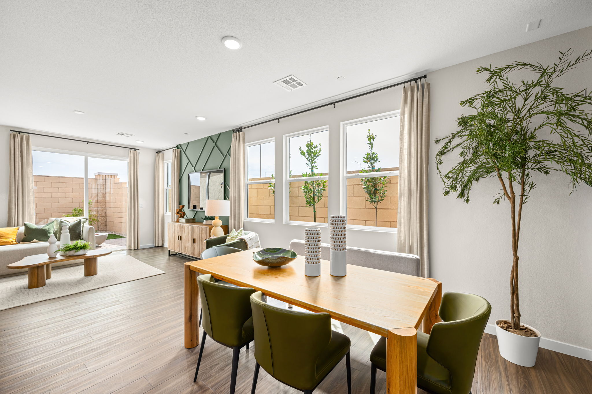 A large living room with a large table and chairs.