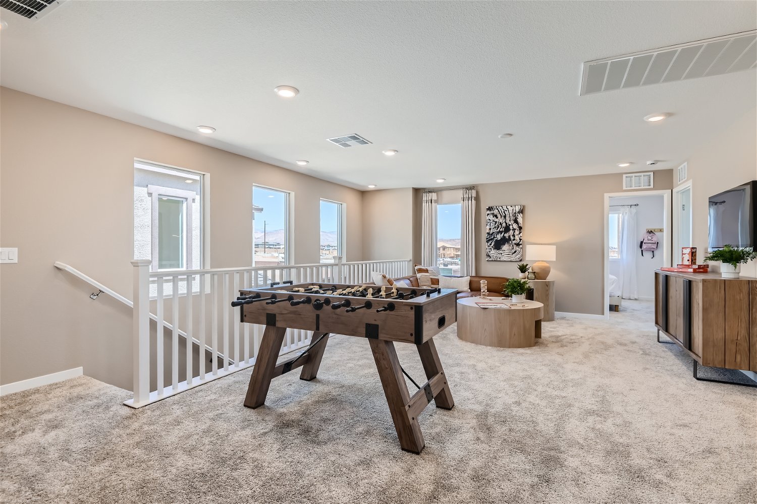 A large room with a table and chairs.