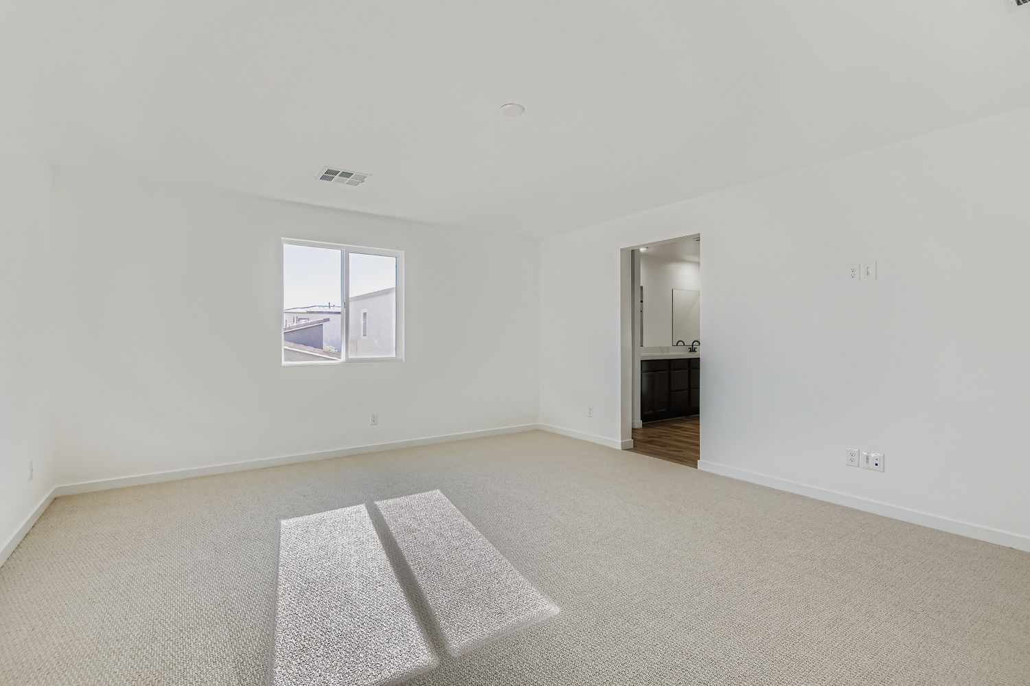 A room with a rug and a door.