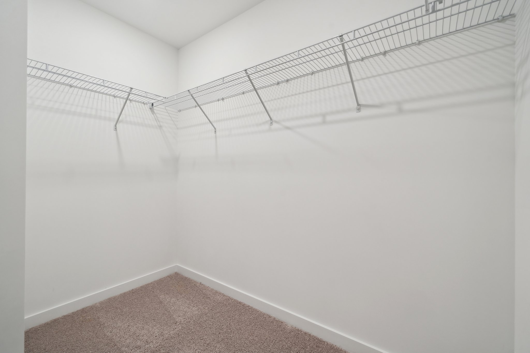A white wall with a white floor.