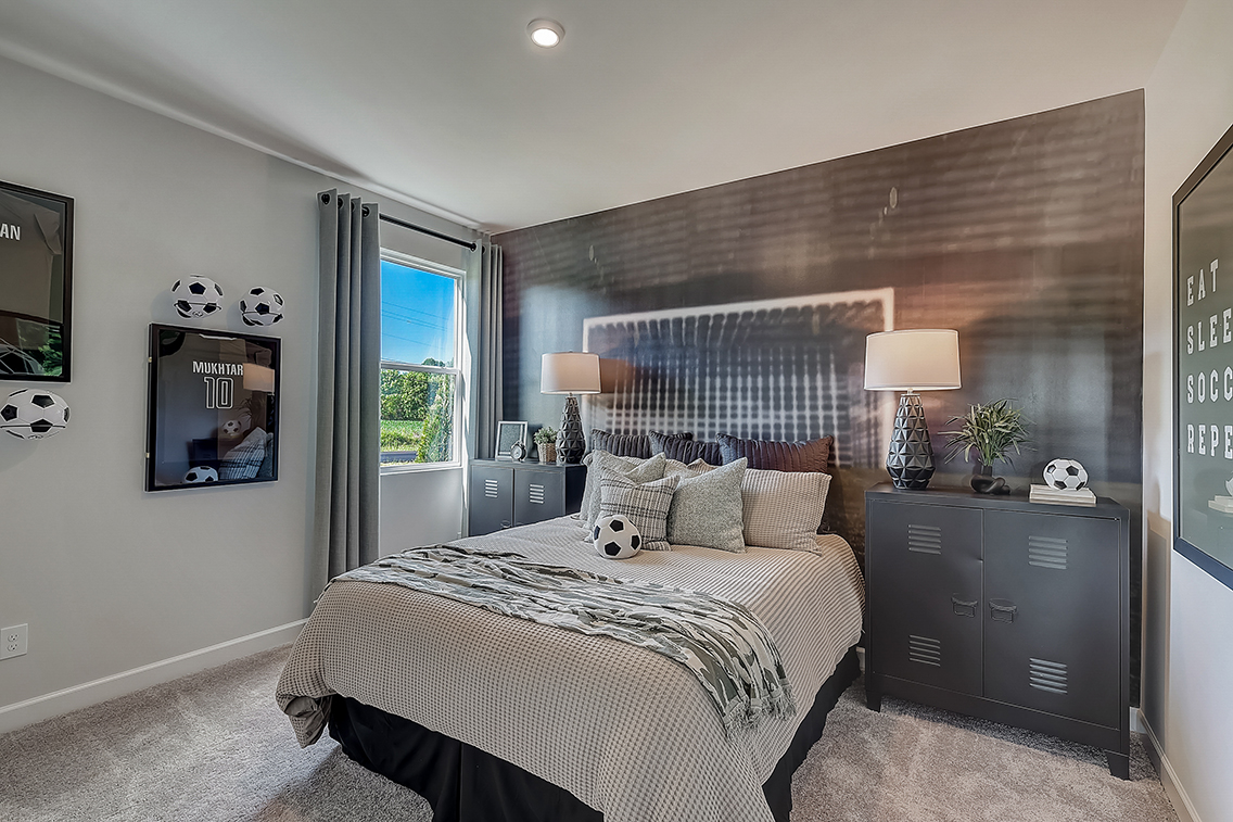 A bedroom with a bed and lamps.