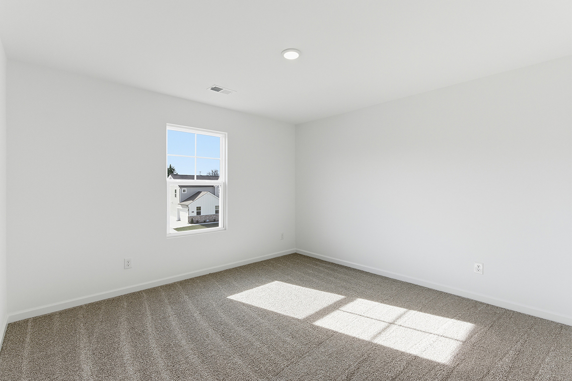 A room with a window and a tile floor.