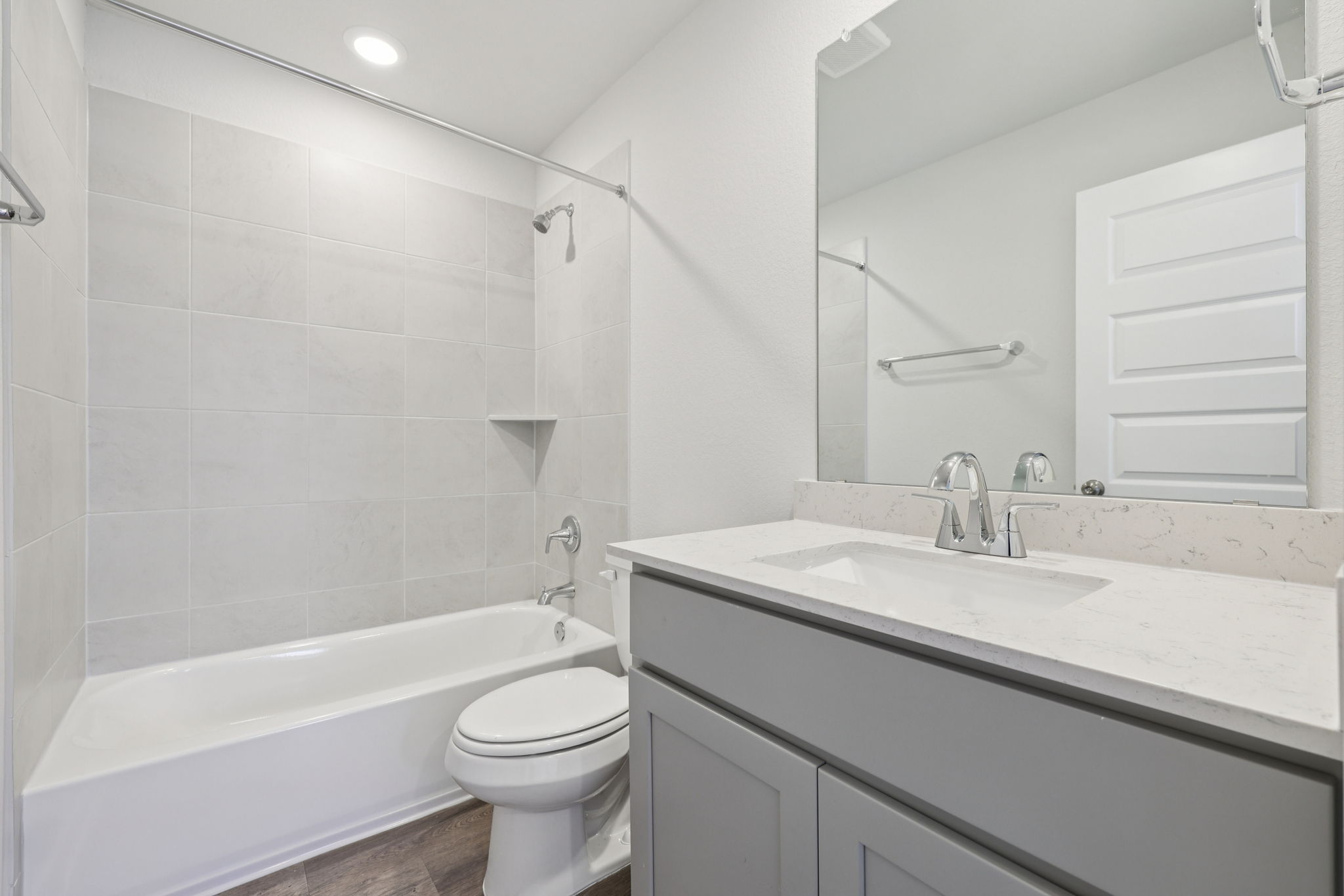 A bathroom with a tub sink and toilet.