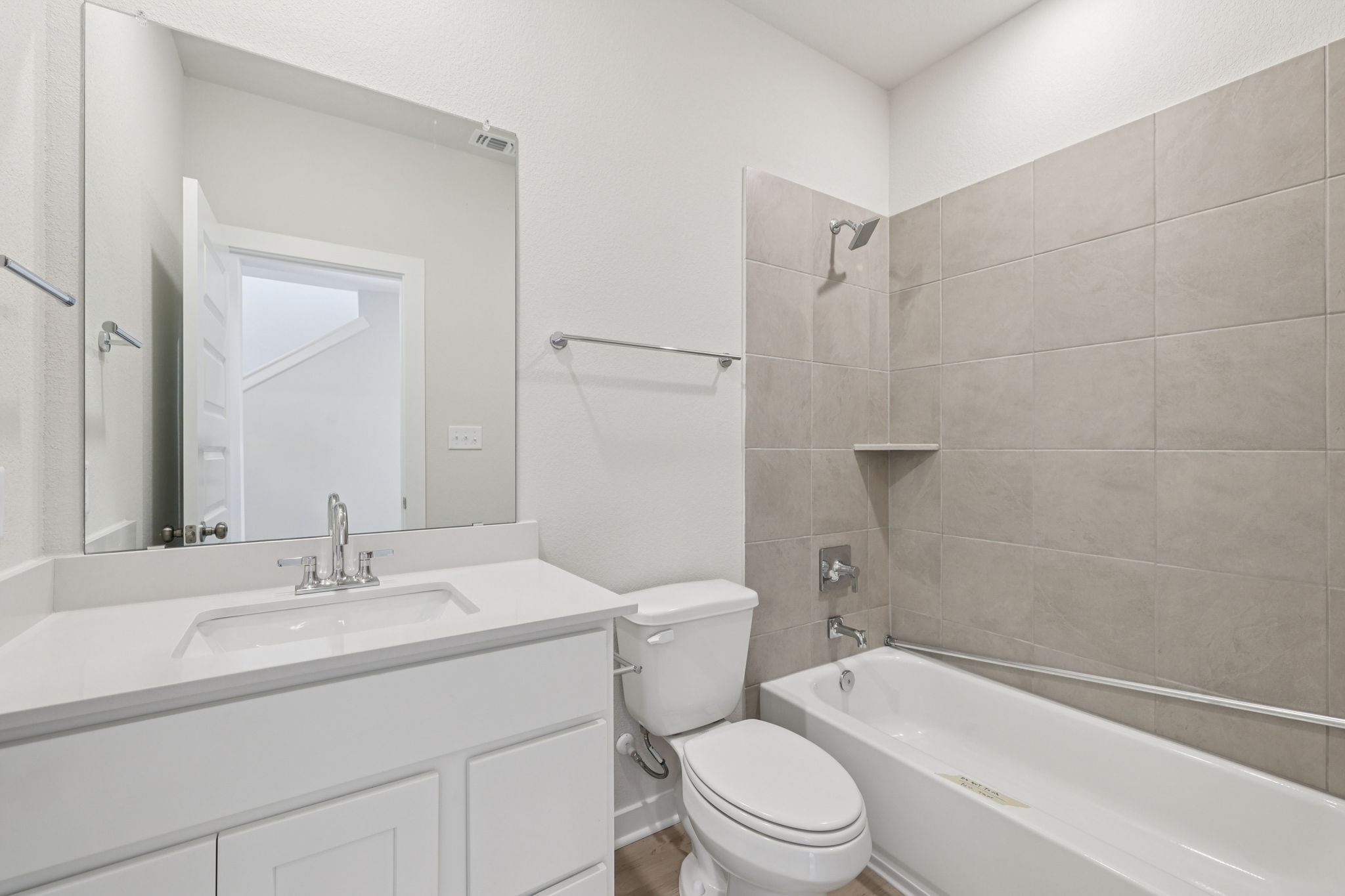A bathroom with a tub sink and toilet.