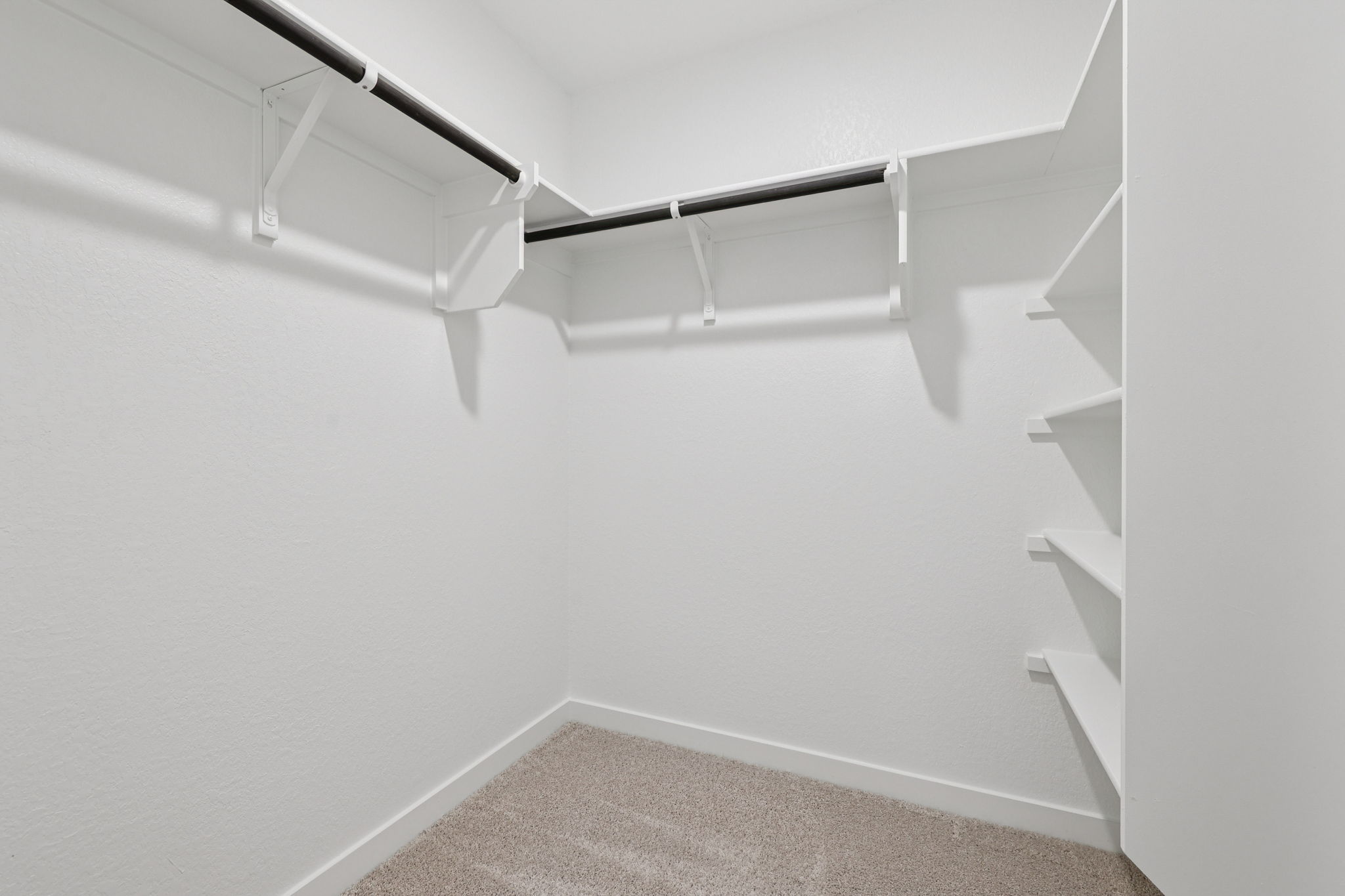 A white wall with a metal ladder.