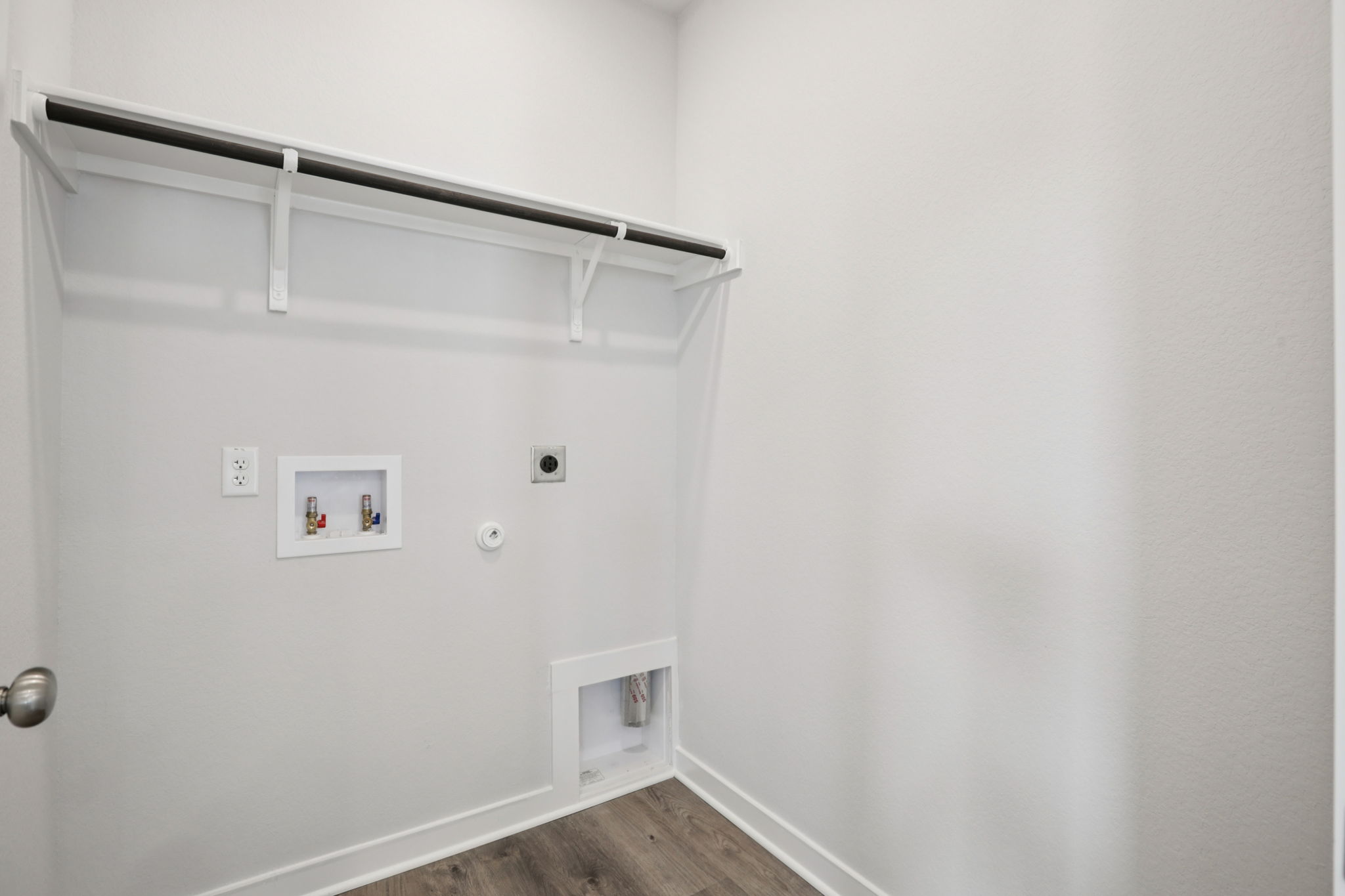 A white wall with a white door.