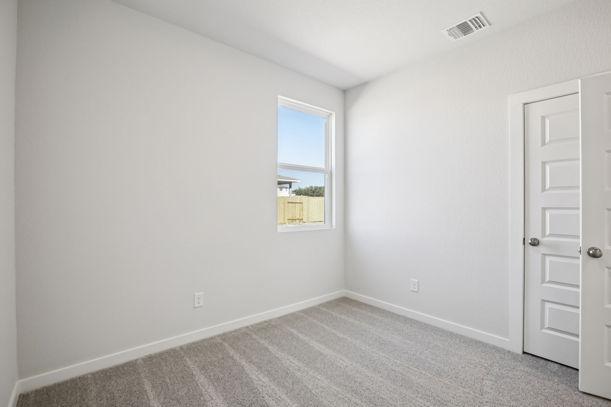 A room with a window and a door.