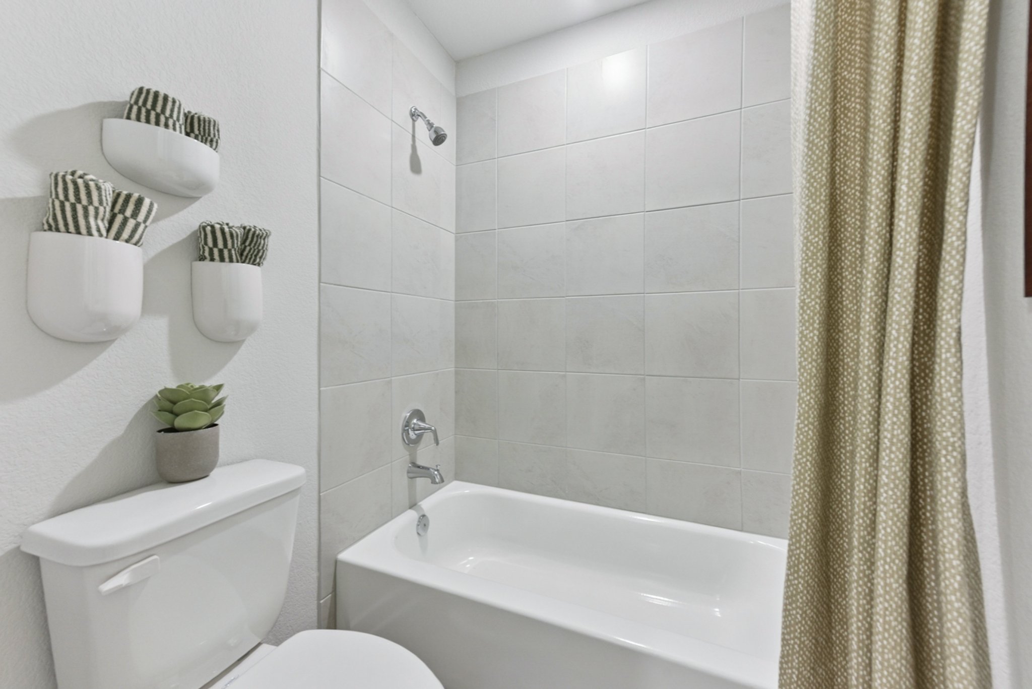 A bathroom with a tub toilet and sink.