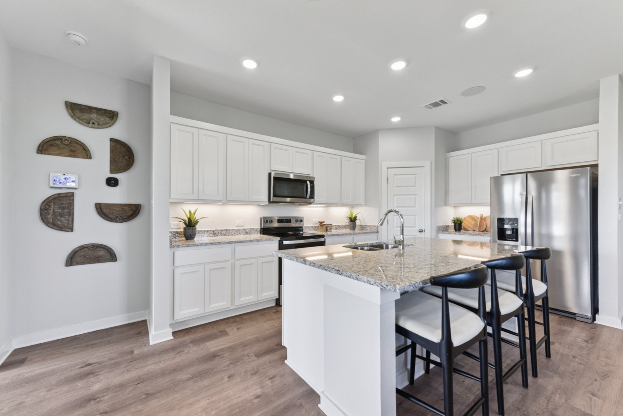 A kitchen with white cabinets.