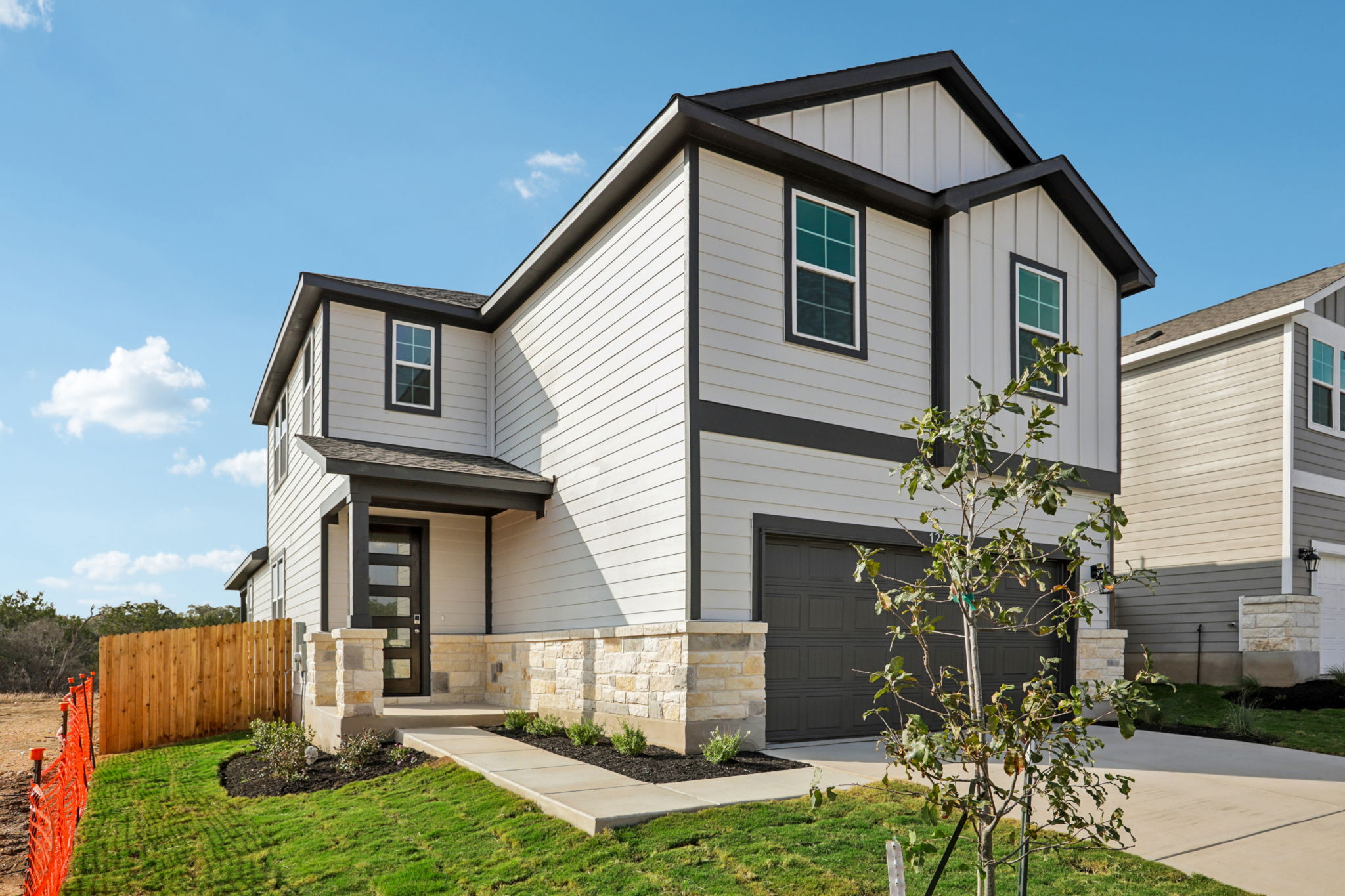 A house with a fence and trees.