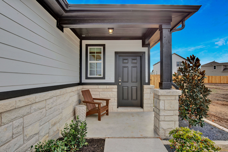 A house with a patio and a bench.