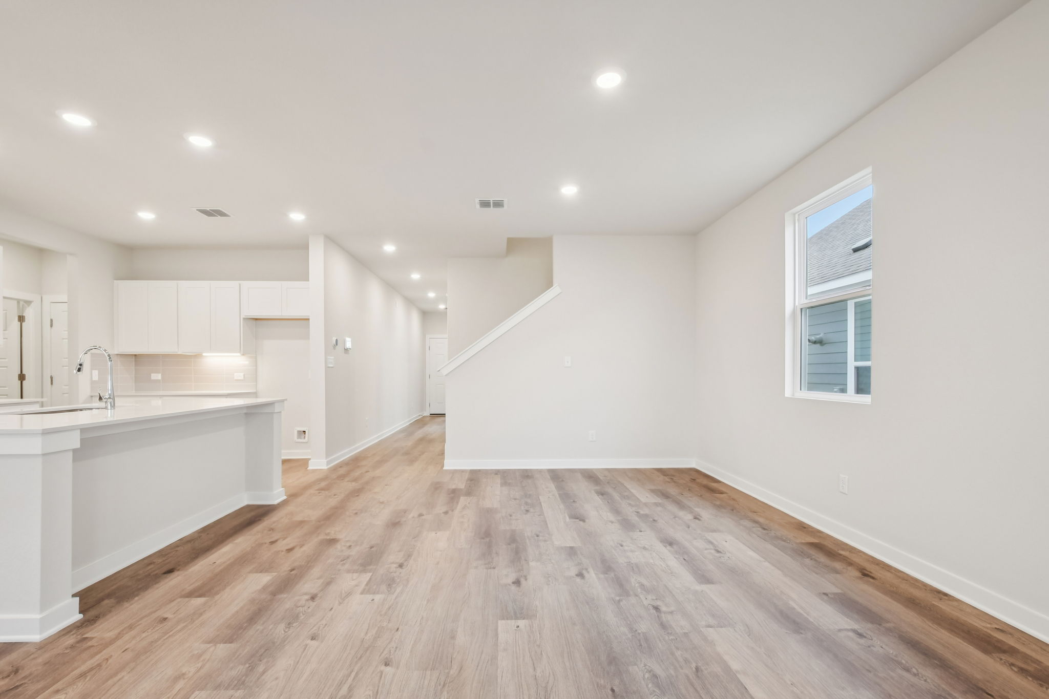 A kitchen with white cabinets.