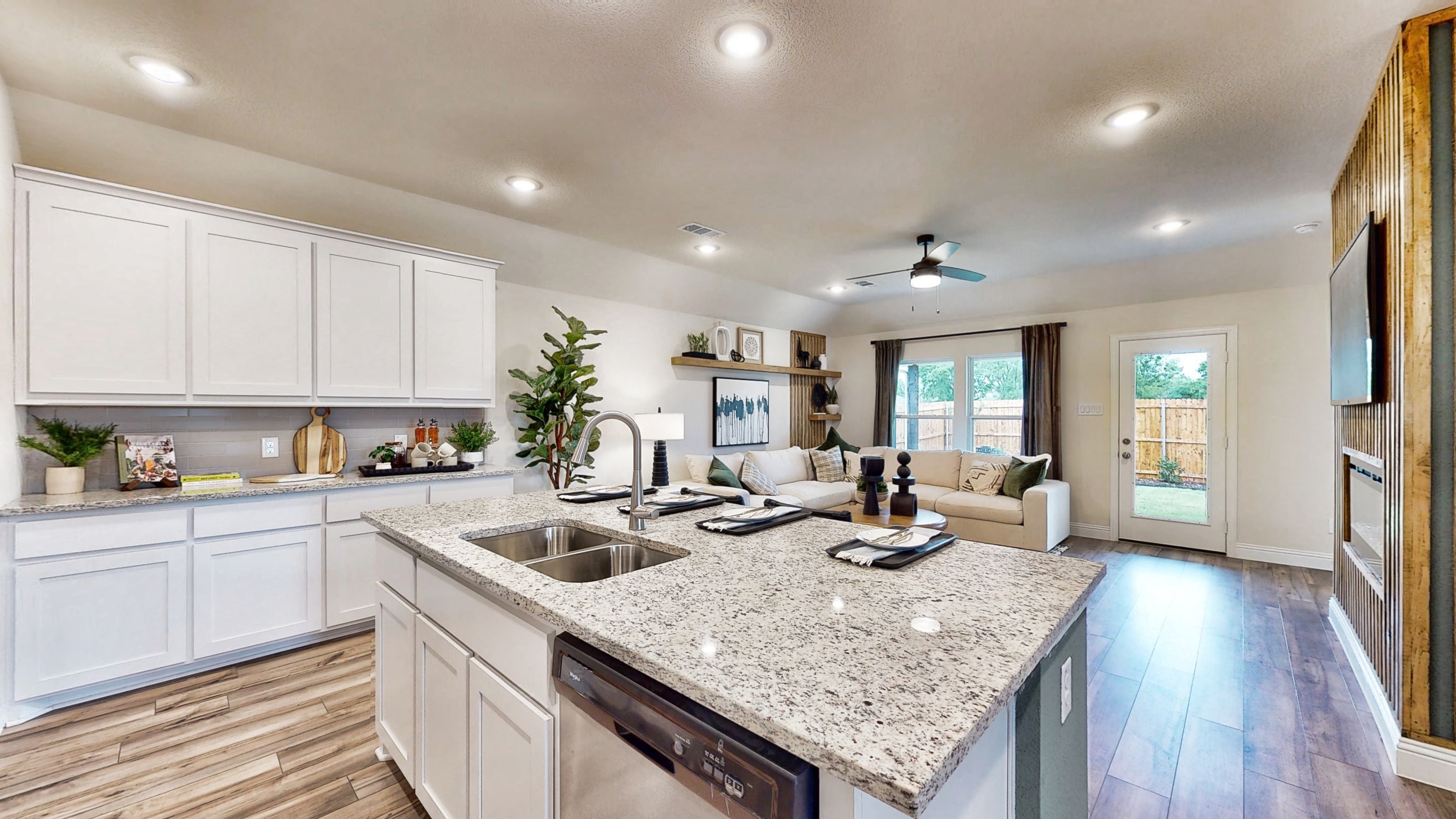 A kitchen with white cabinets.