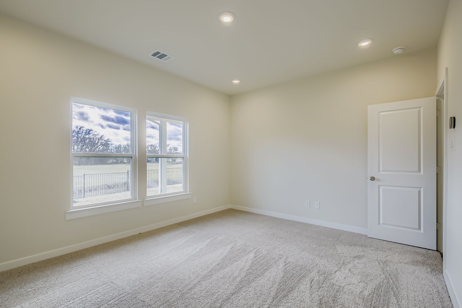 A room with a window and a door.