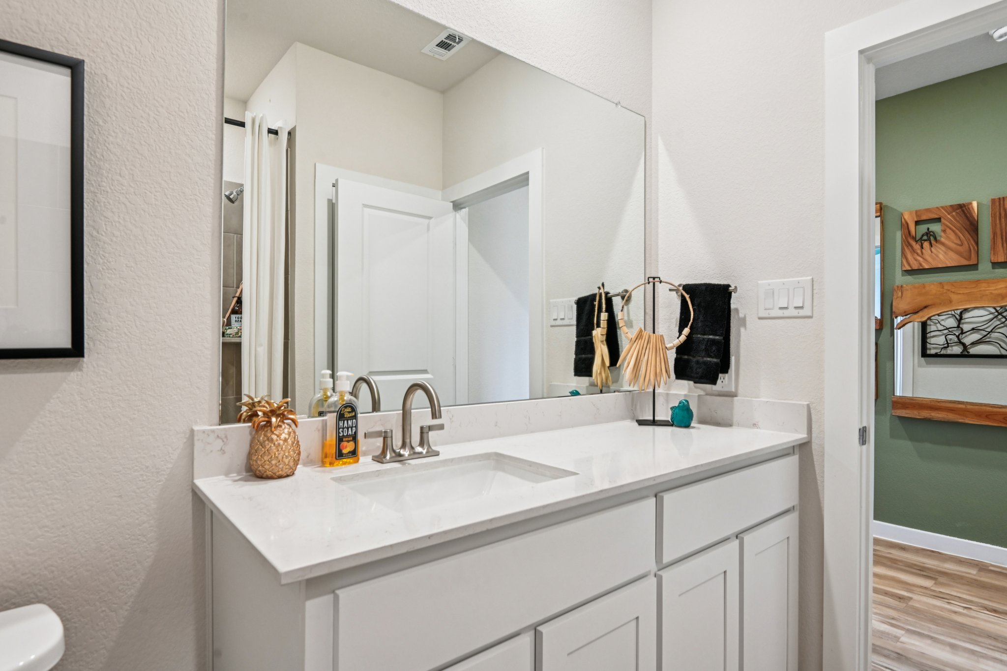 A bathroom with a large mirror.