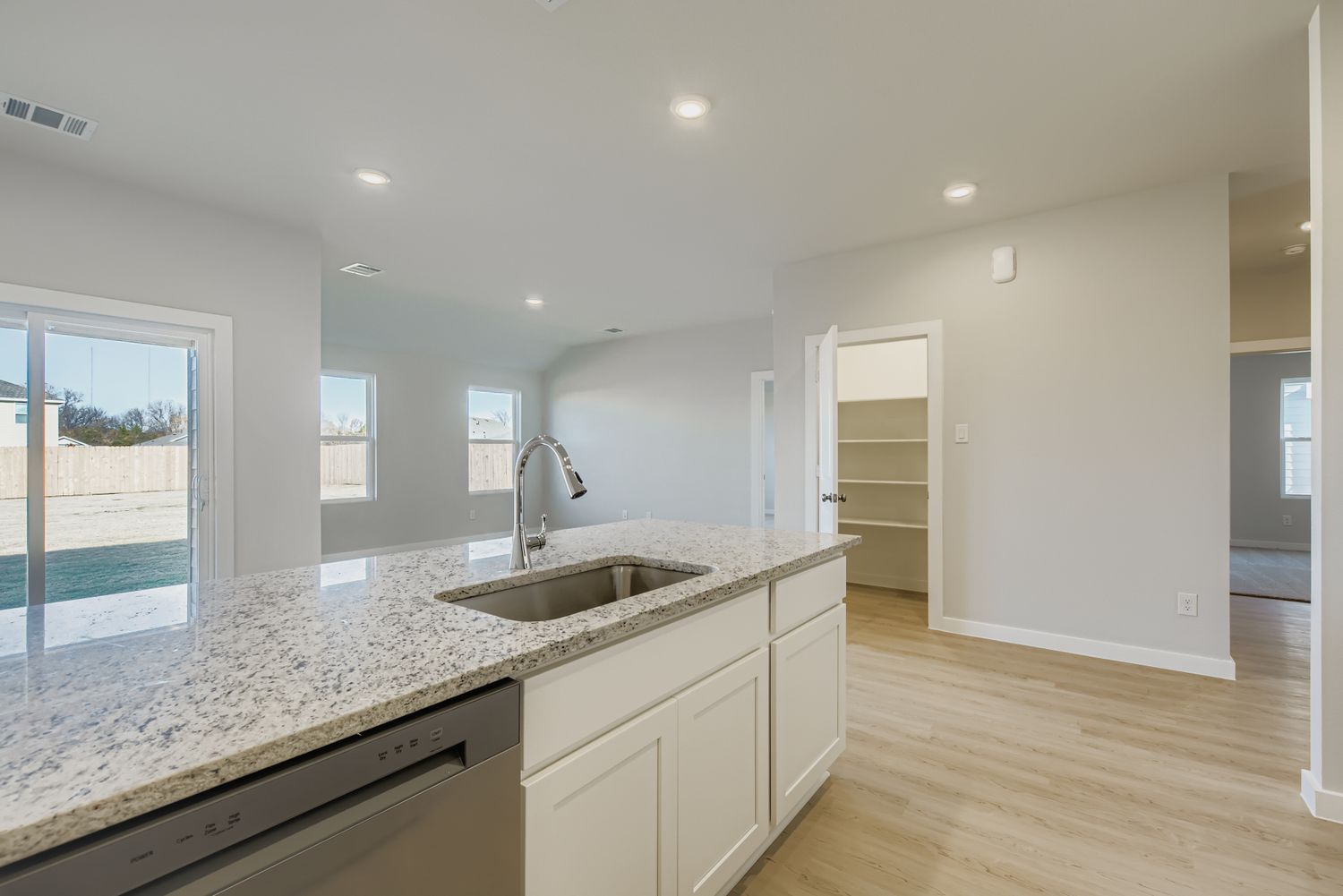 A kitchen with marble counters.