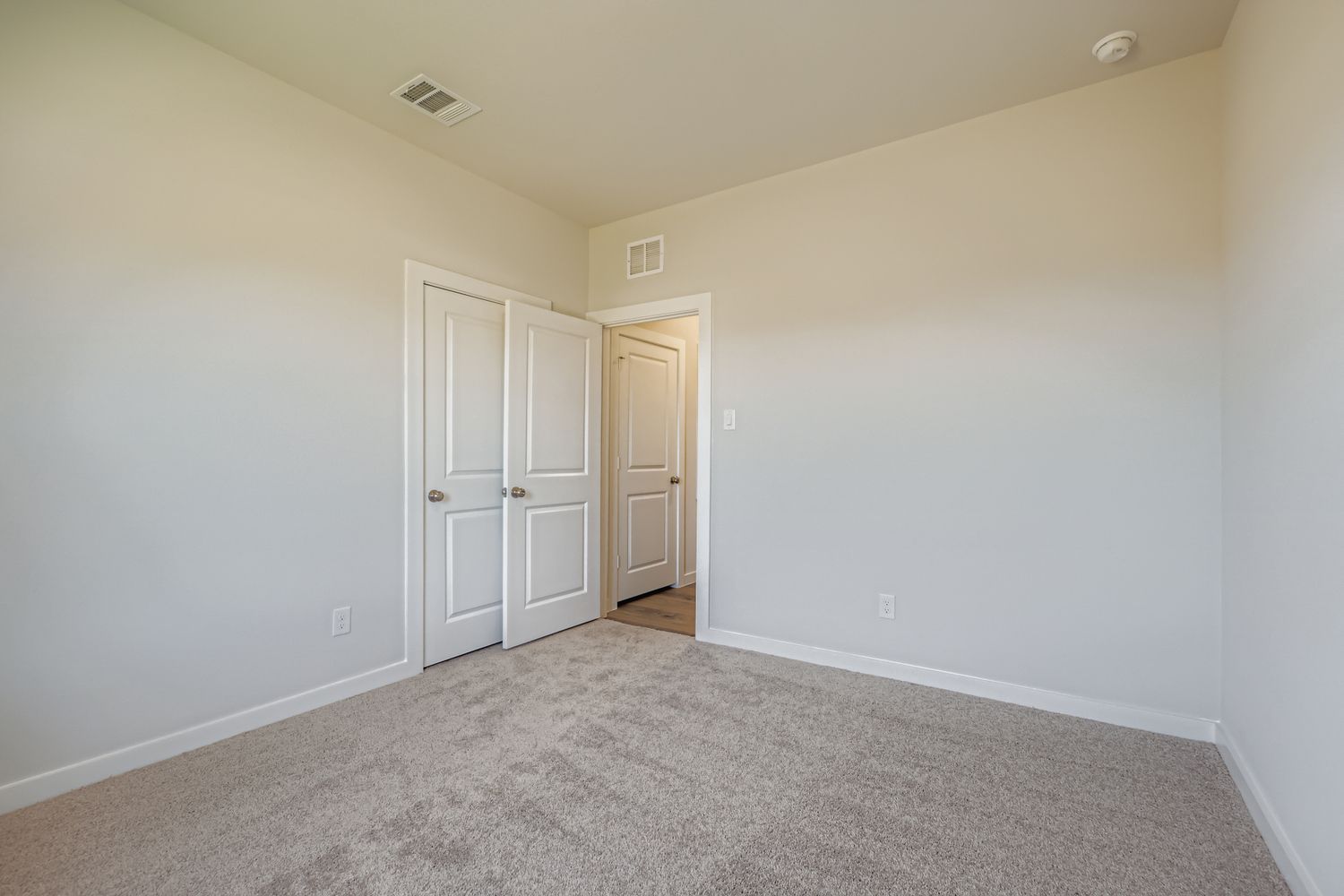 A hallway with white doors.