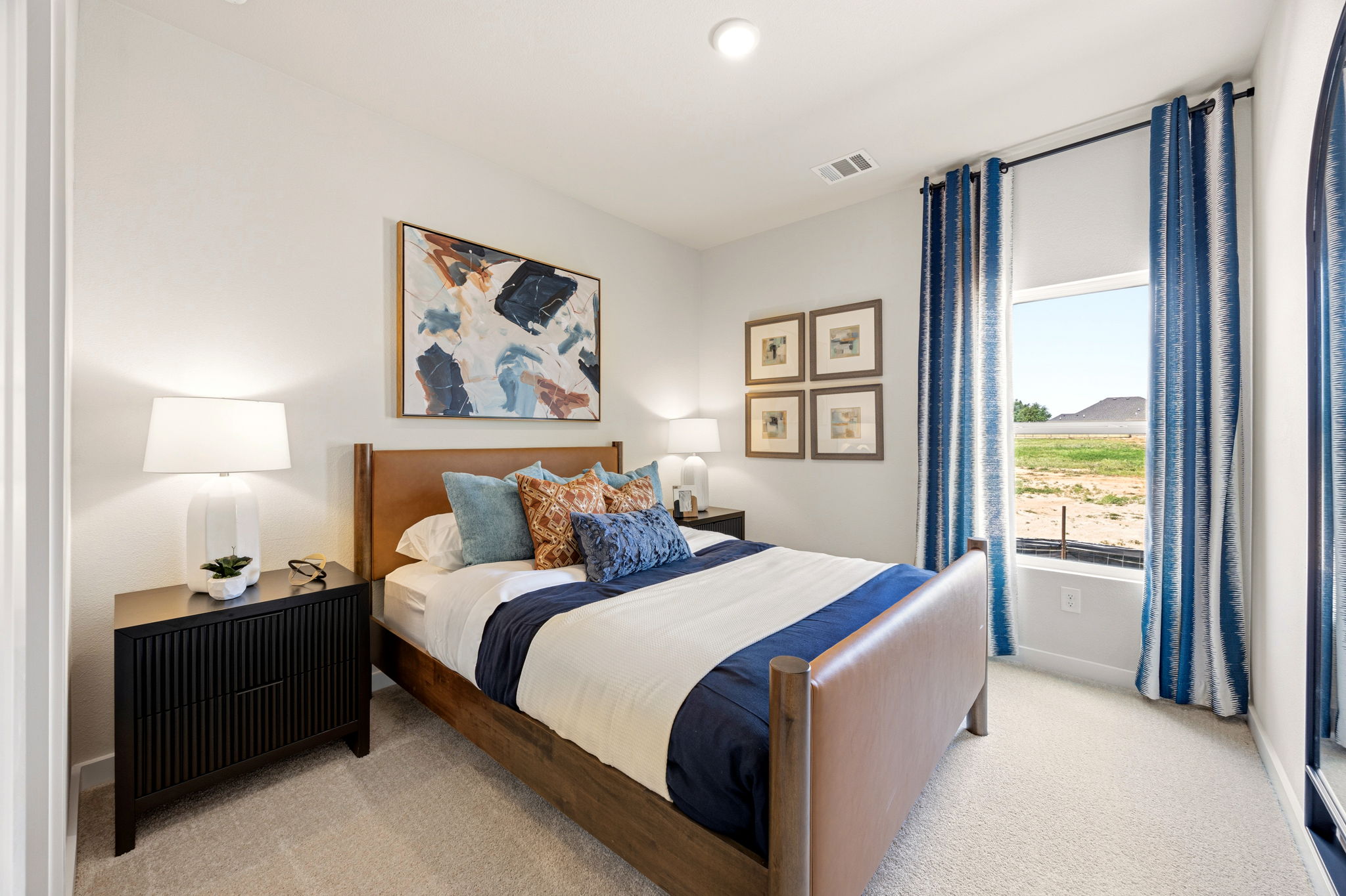 A bedroom with a large window.