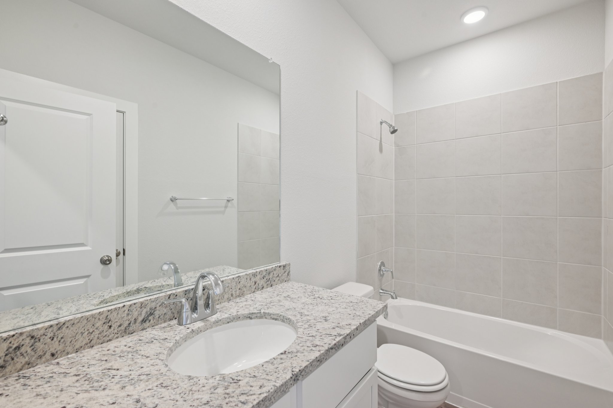 A bathroom with a marble countertop.