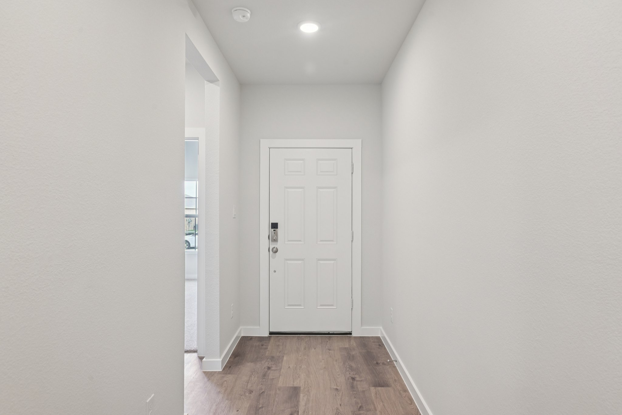 A hallway with white doors.
