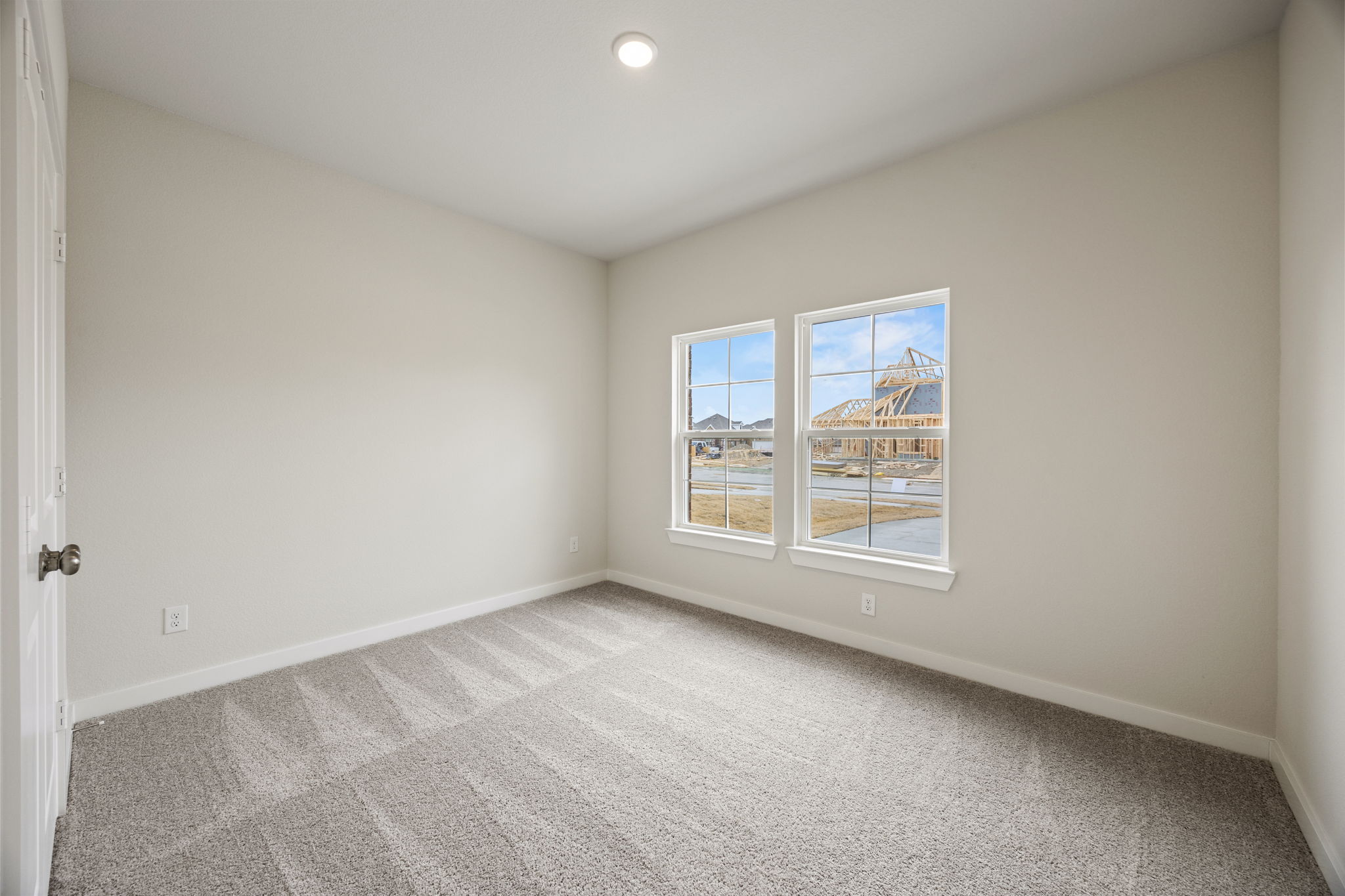 A room with a window and carpet.
