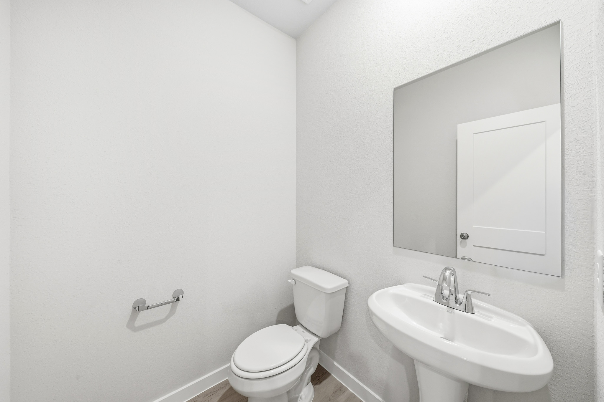 A bathroom with a toilet and sink.