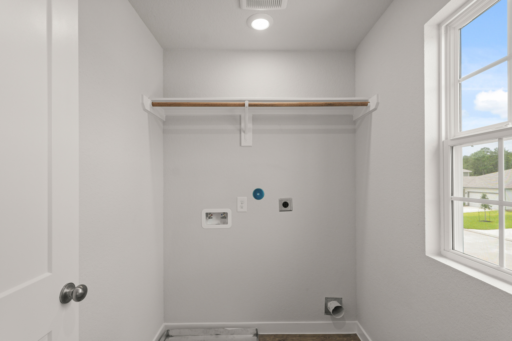 A white wall with a window.