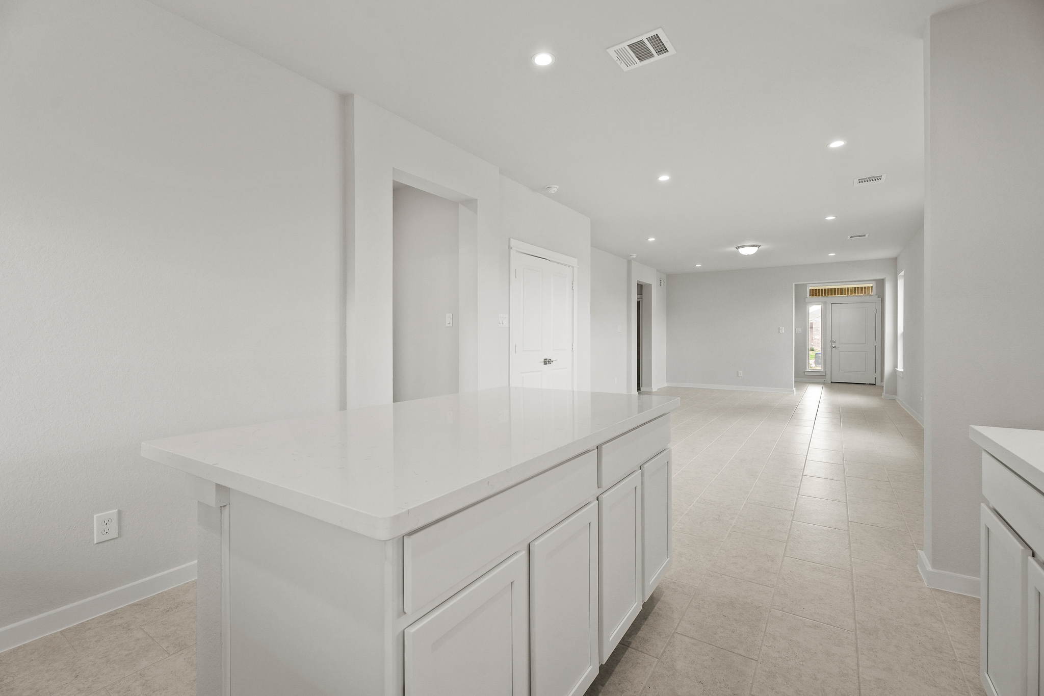 A large white room with white cabinets.