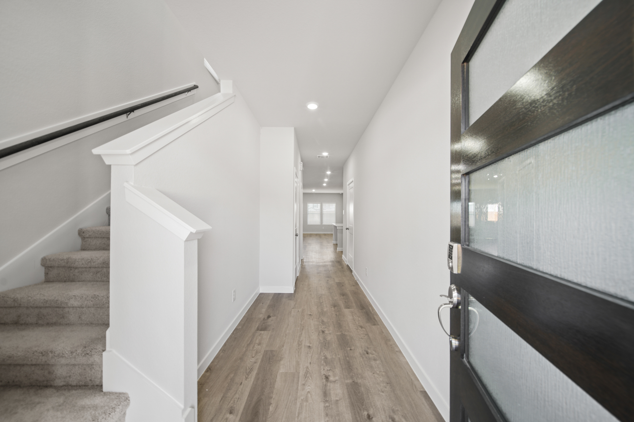 A hallway with white walls.