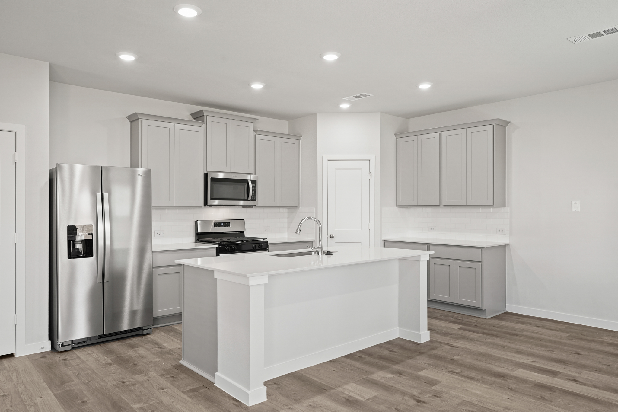 A kitchen with white cabinets.