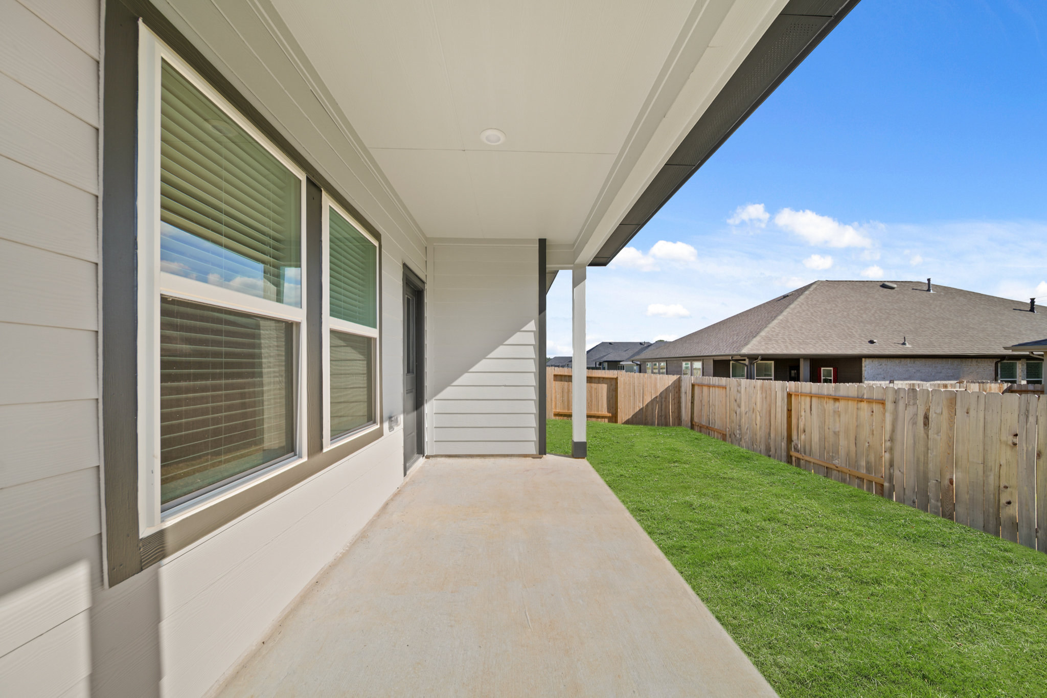 A house with a fence and grass.