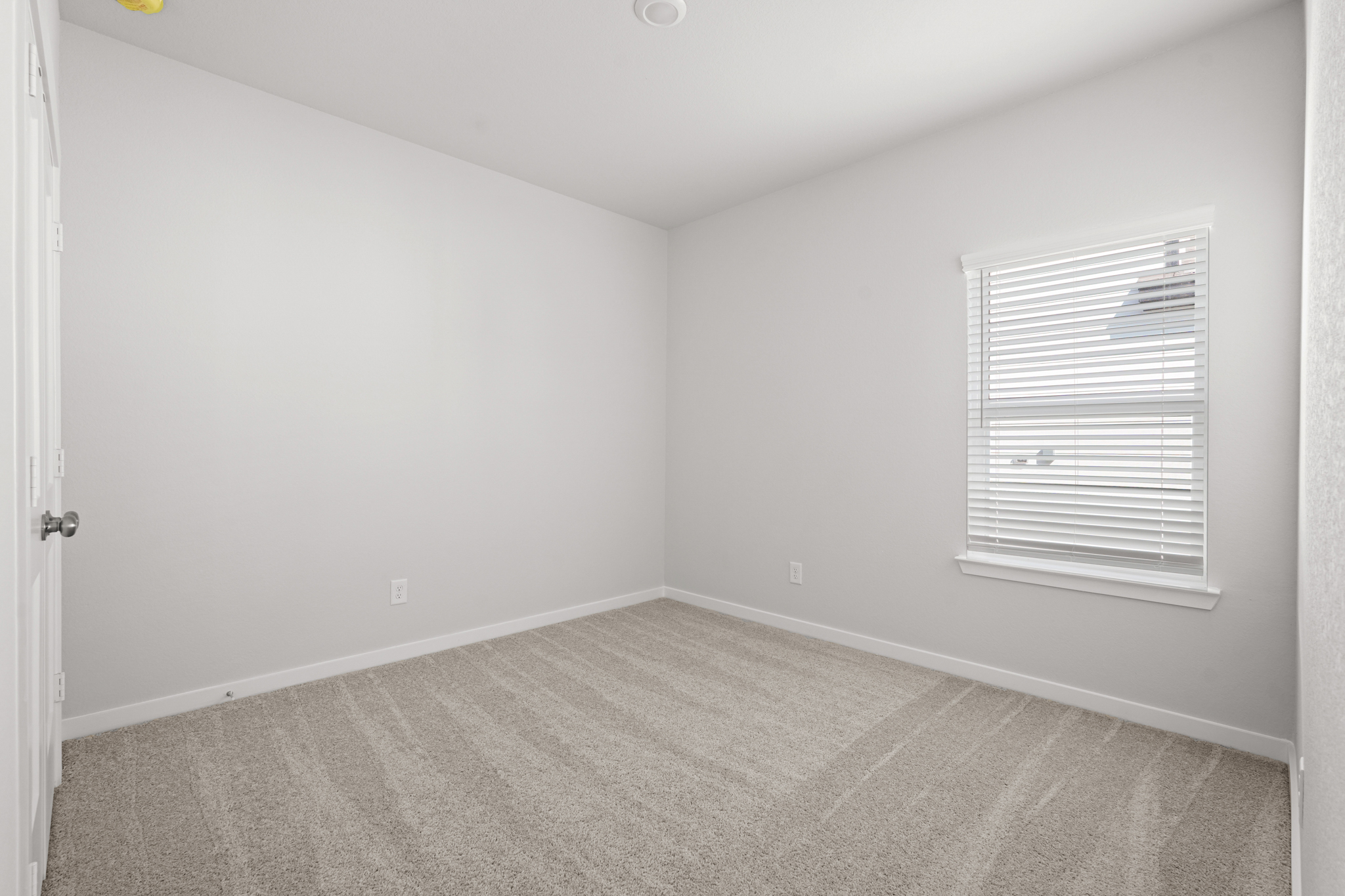 A room with a door and a window.