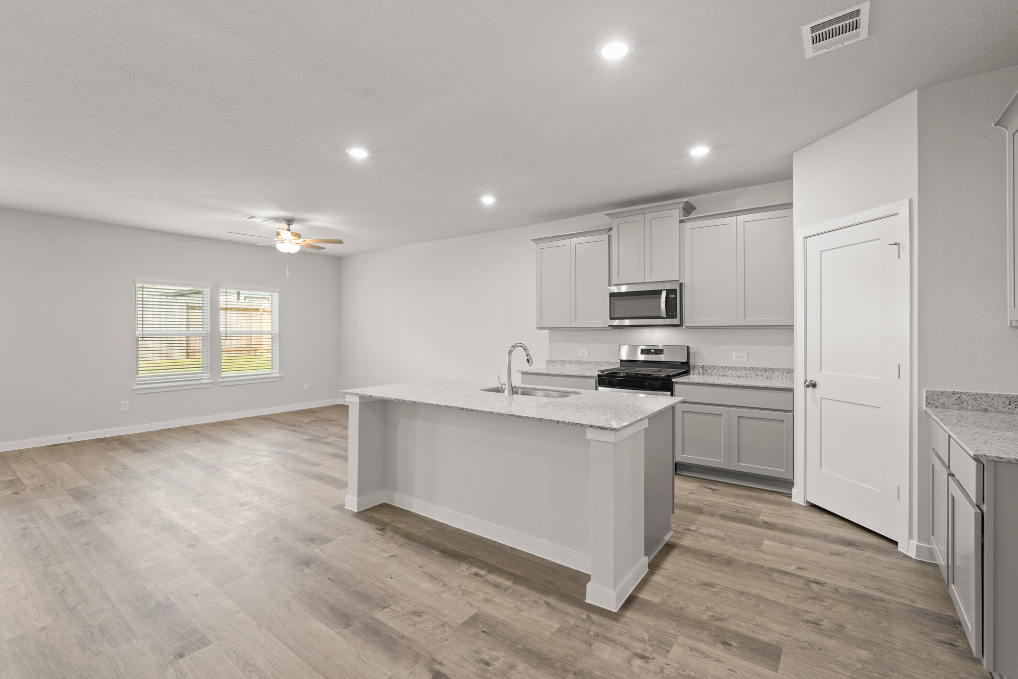 A kitchen with white cabinets.