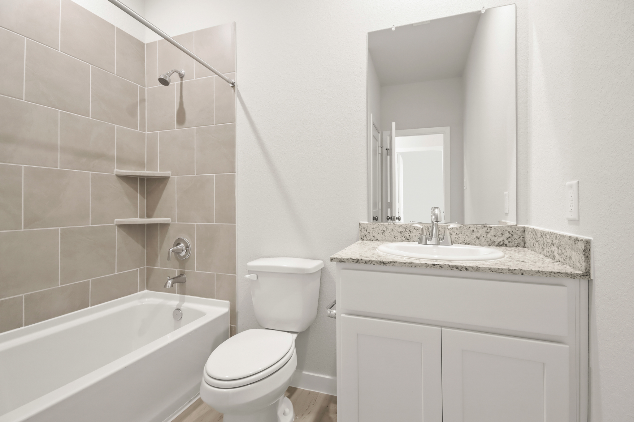 A bathroom with a tub sink and toilet.