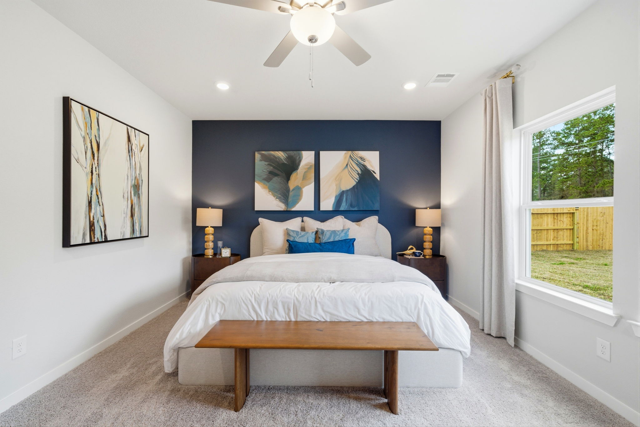 A bedroom with a bed and a fan.