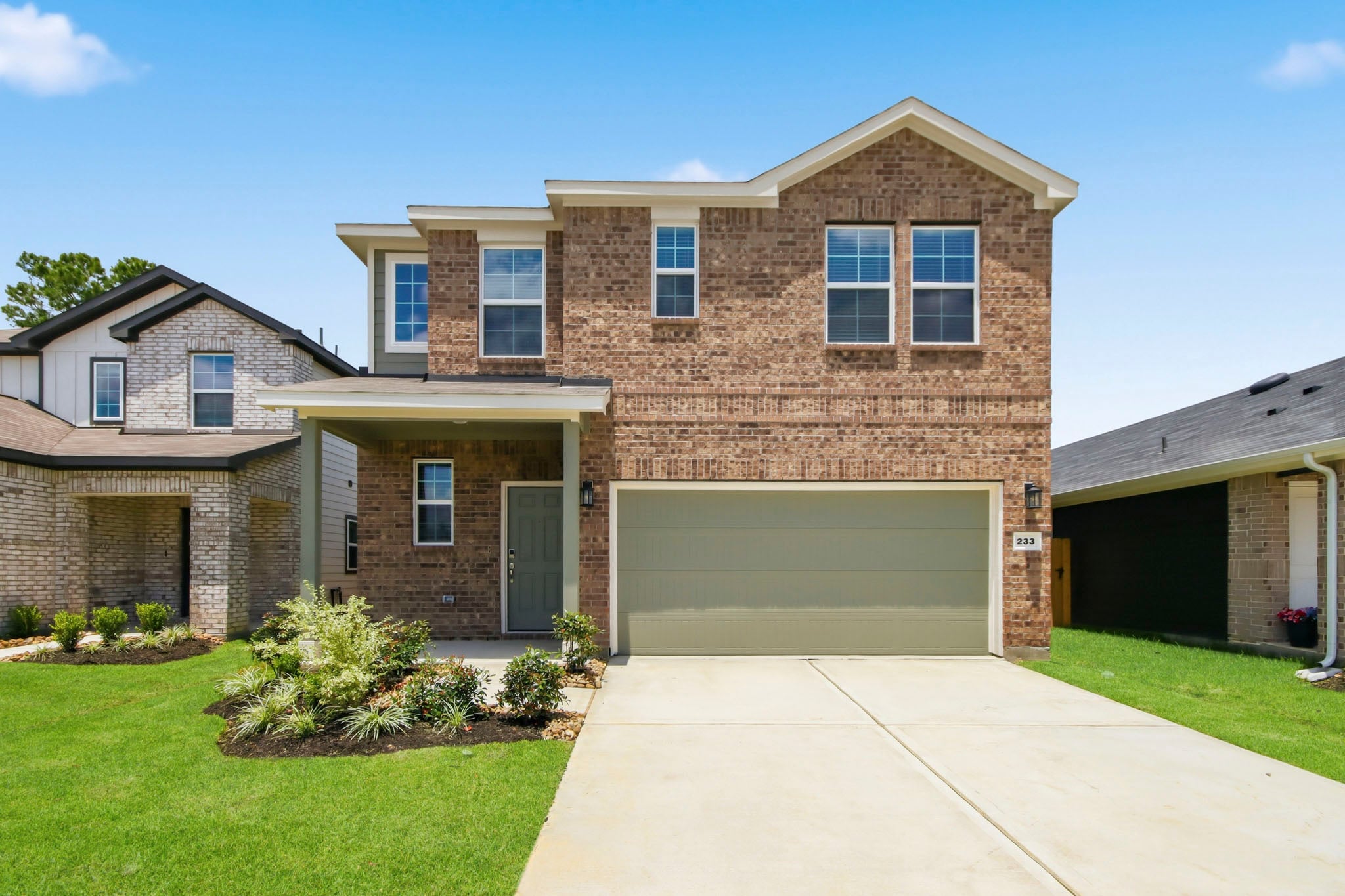 A brick house with a garage.