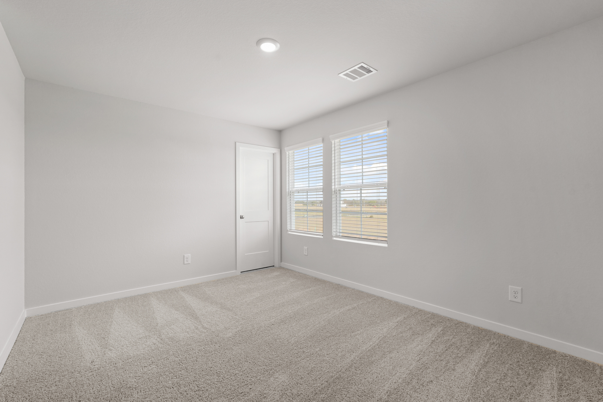 A room with a door and windows.