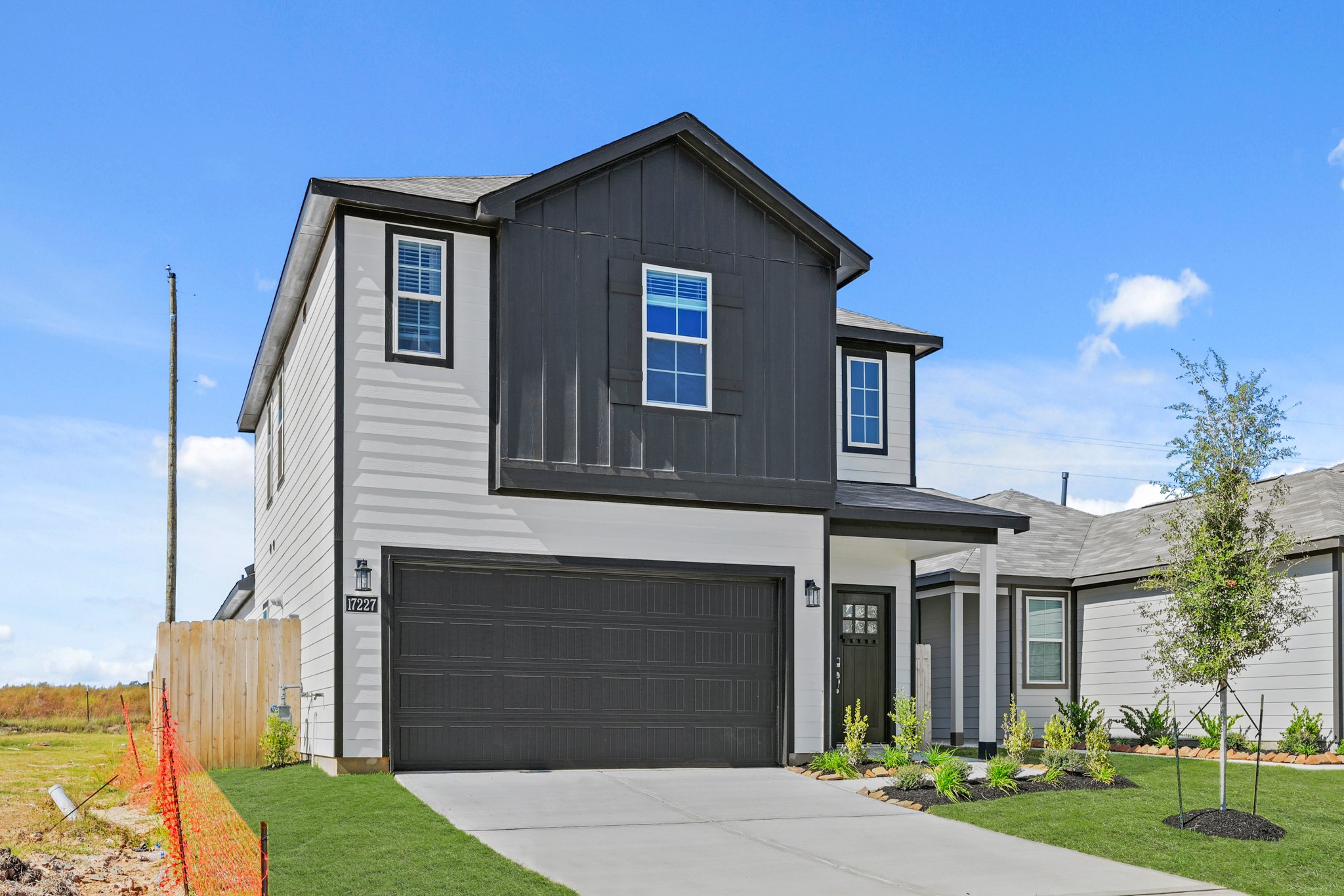 A grey house with a garage.