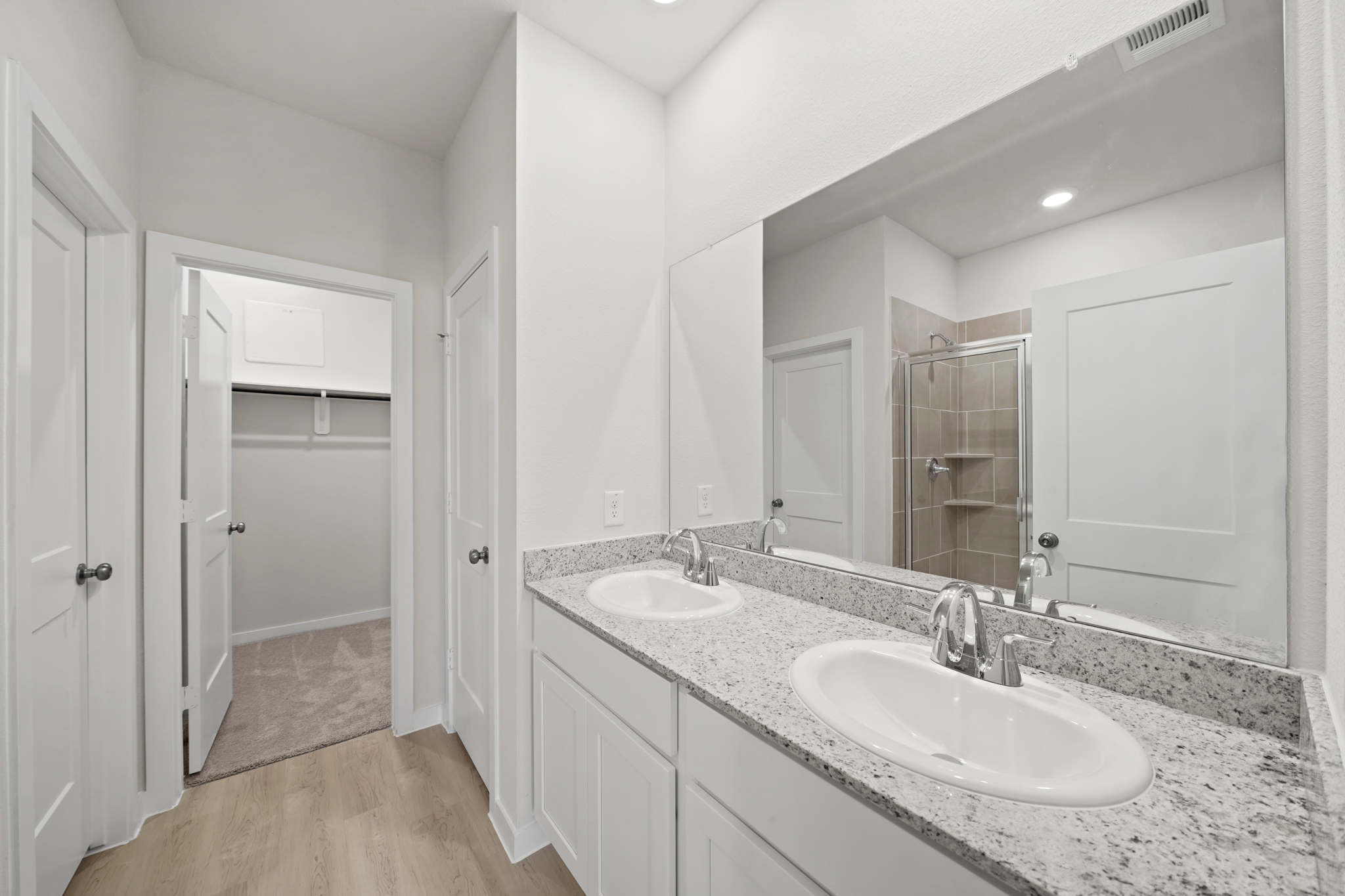 A bathroom with a large mirror.